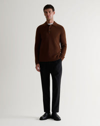 Image 1 of 6 of man wearing Rise & Fall's burl brown cashmere merino fisherman ribbed polo with black trousers and black shoes