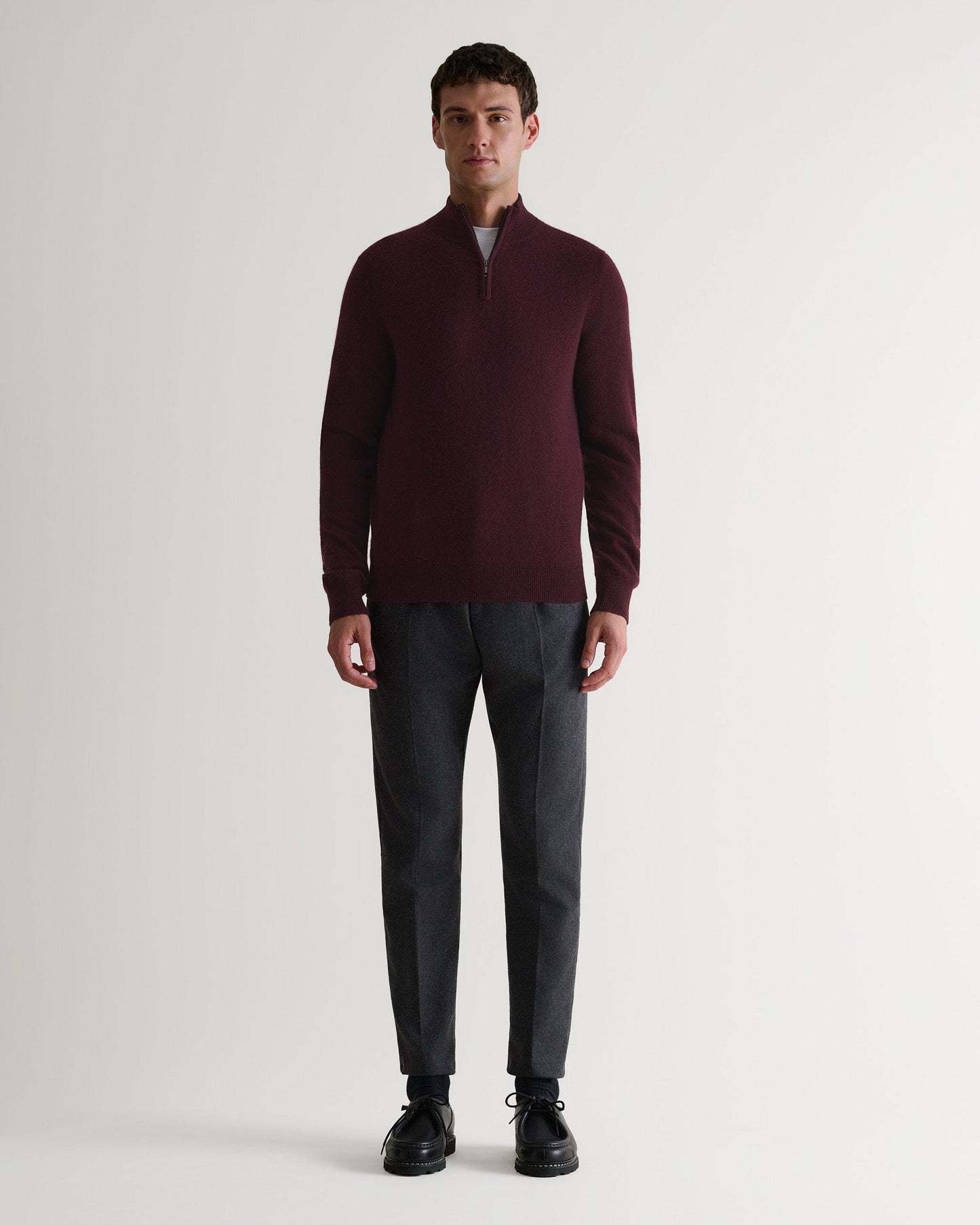 Image 1 of 6 showing man wearing Rise & Fall's fine cashmere 1/4 zip jumper, oxblood.