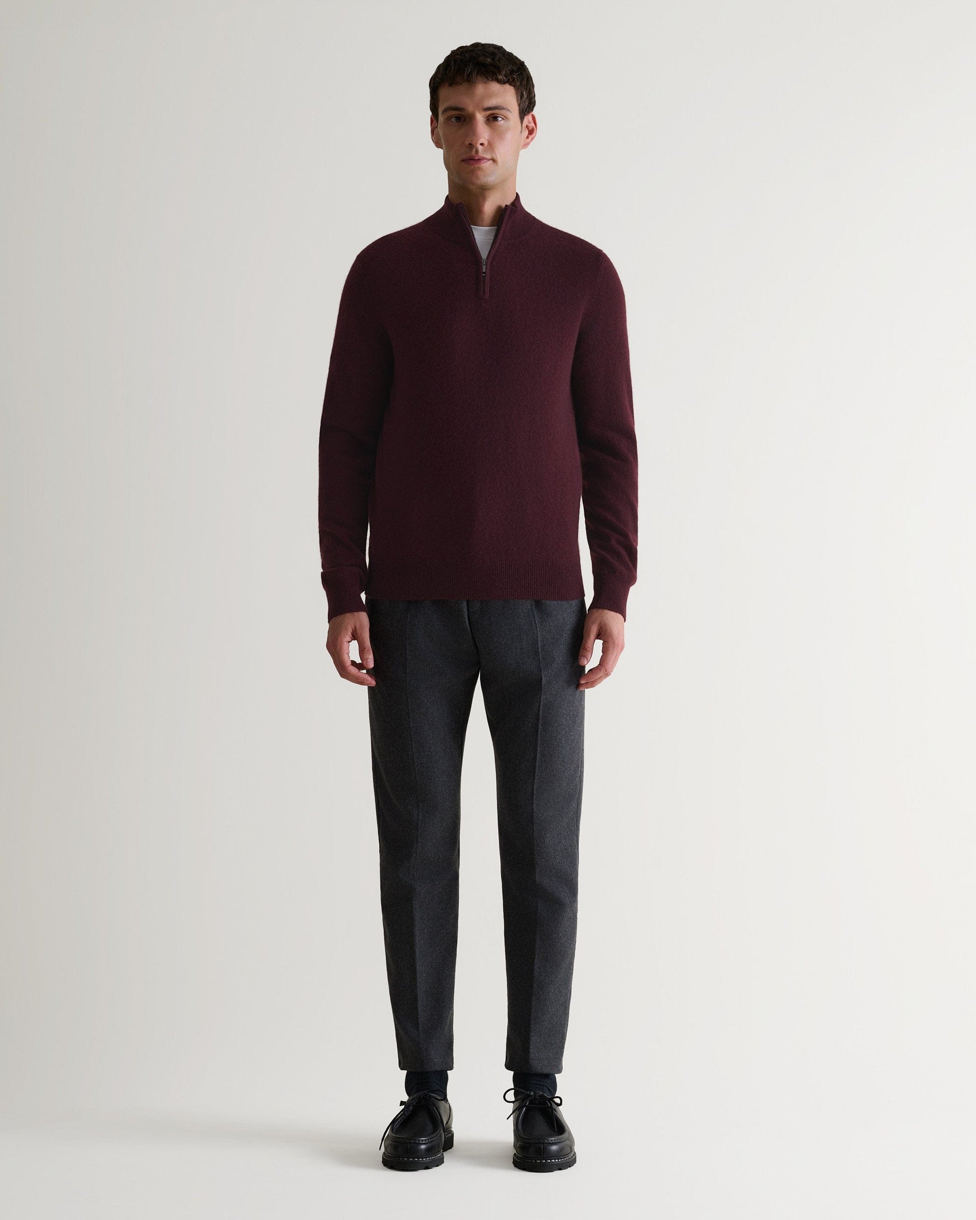Image 1 of 6 showing man wearing Rise & Fall's fine cashmere 1/4 zip jumper, oxblood.