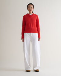 Image 1 of 6 showing woman wearing Rise & Fall cashmere merino saddle sleeve crew neck jumper, colour: poppy red.