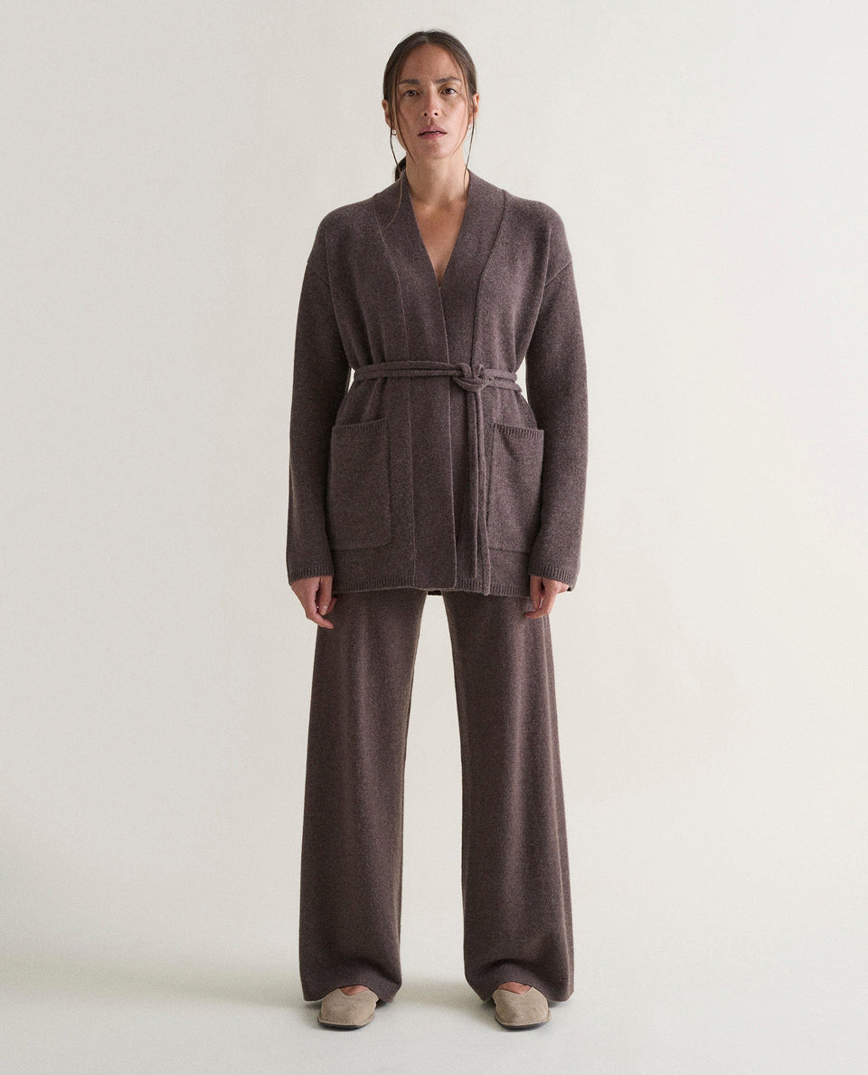 Image 1 of 6 showing woman wearing Rise & Fall's brown cashmere merino belted cardigan with matching cashmere trousers.