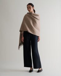 Image 1 of 7 showing woman wearing Rise & Fall's finest cashmere double faced wrap twine side with black trousers.