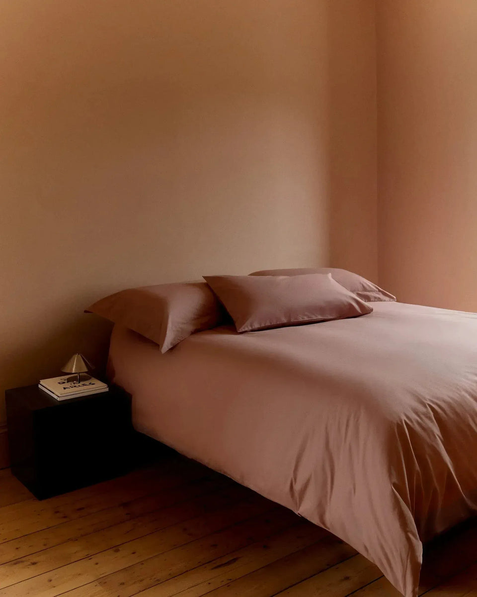 Image 2 of 3 showing bed with Rise &  Fall's clay Crisp & Cool Duvet Set in cotton percale.