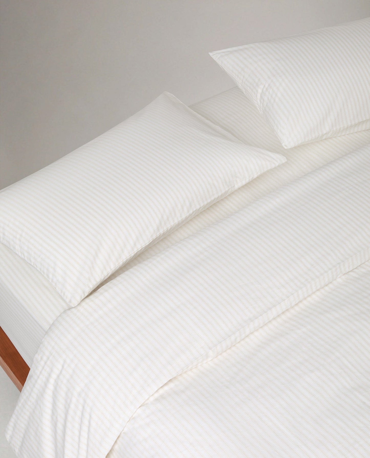 Image 2 of 3 showing Rise & Fall's Crisp & Cool Organic Cotton Pillowcases Set, colour: Buttermilk Ticking Stripe.