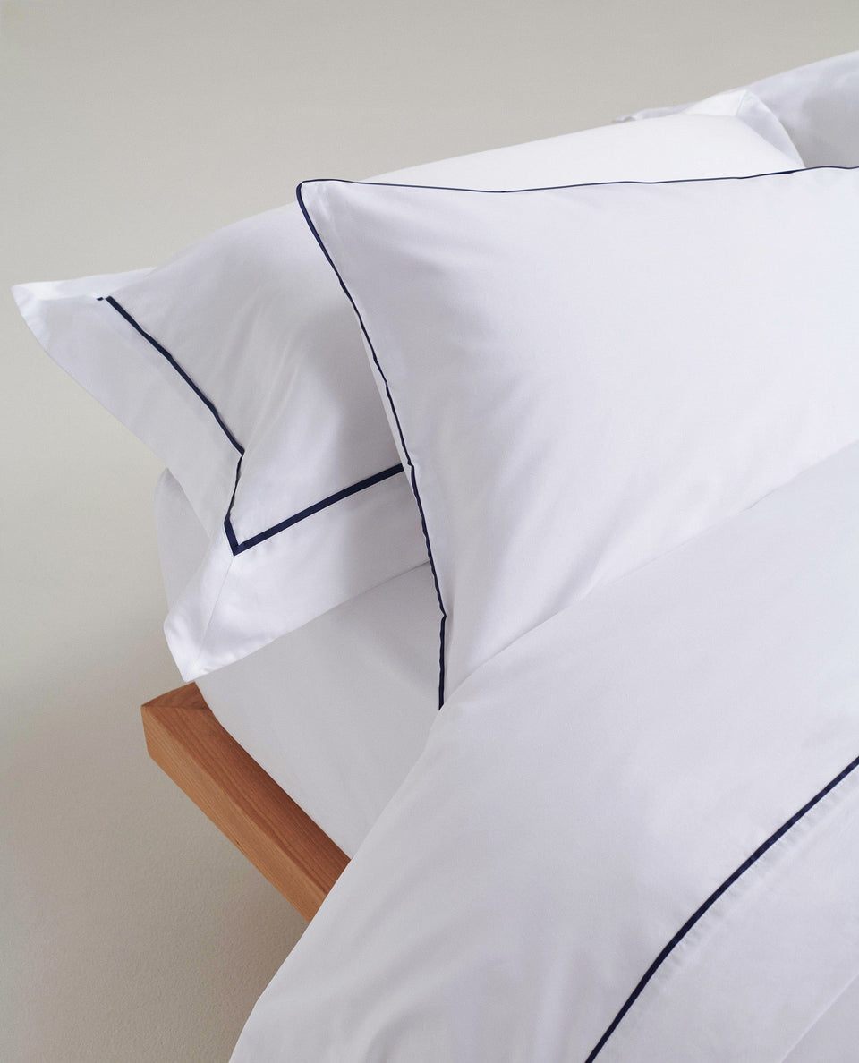 image 2 of 3 showing bed with Rise & Fall's Crisp & Cool duvet set, colour: white navy piping, fabric: percale cotton