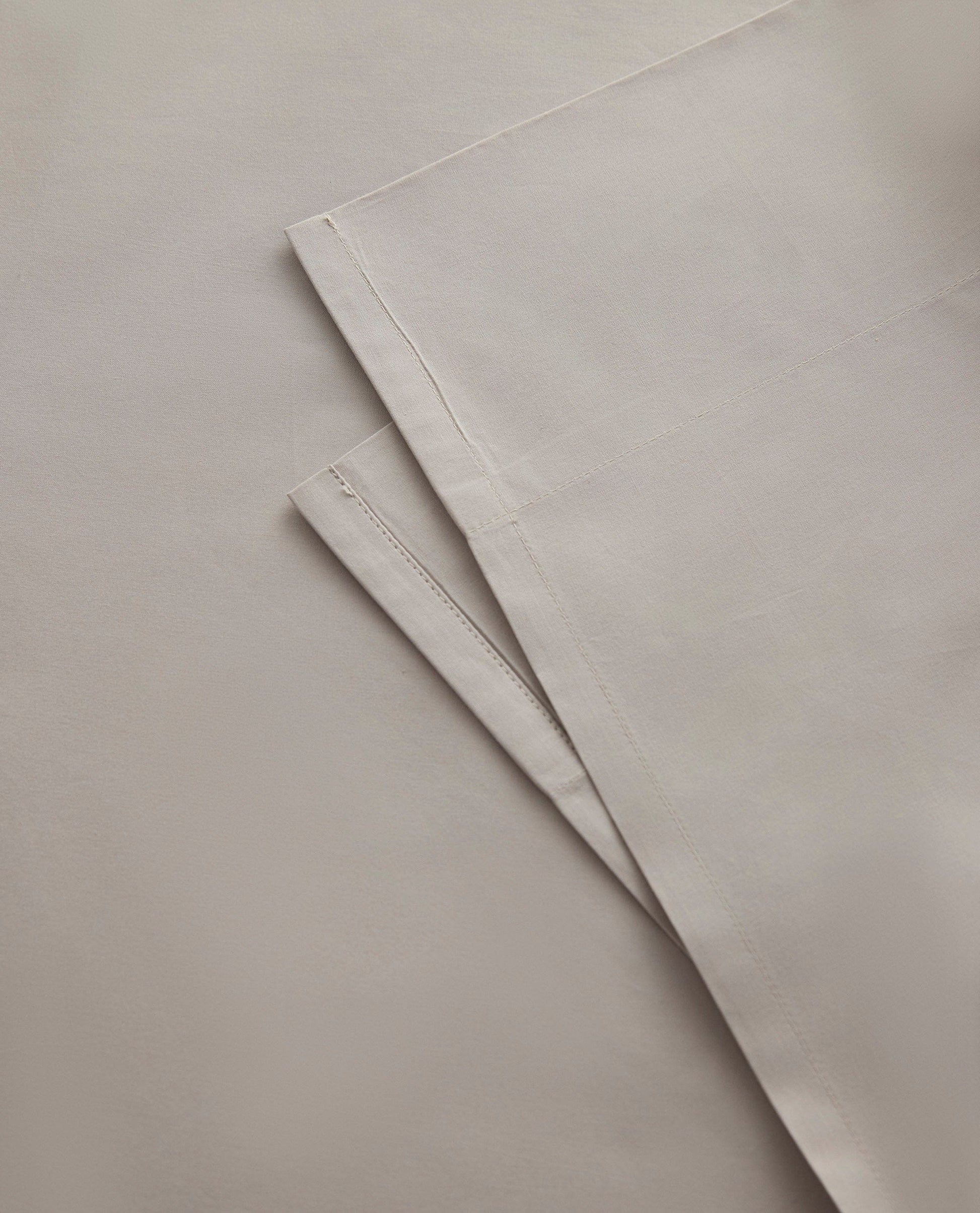Image 2 of 3 showing Rise & Fall's Crisp & Cool organic cotton percale flat sheet in pebble.