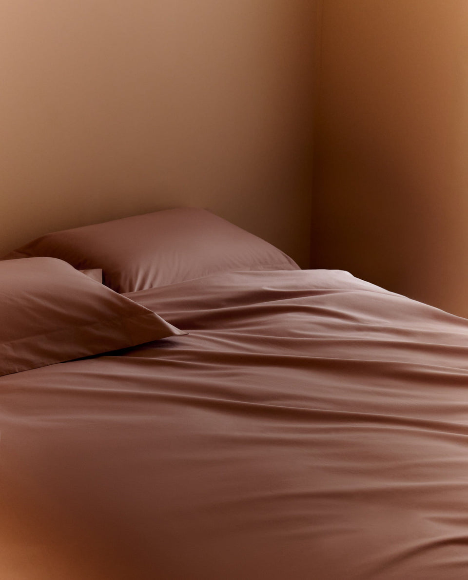 Image 2 of 4 showing Rise & Fall's Crisp & Cool Organic Cotton Percale Pillowcase Set, colour: clay.