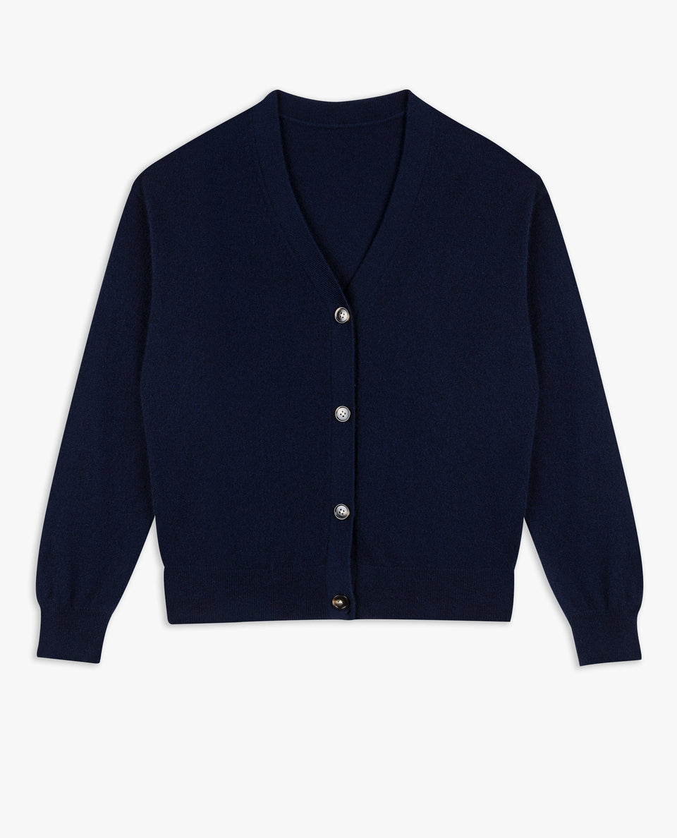 Image 2 of 4 showing Rise & Fall's navy fine cashmere v-neck cardigan with olive trousers.