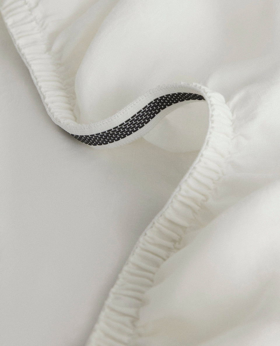 Image 2 of 5 showing Rise & Fall's Relaxed & Refined European flax™ linen fitted sheet in white.