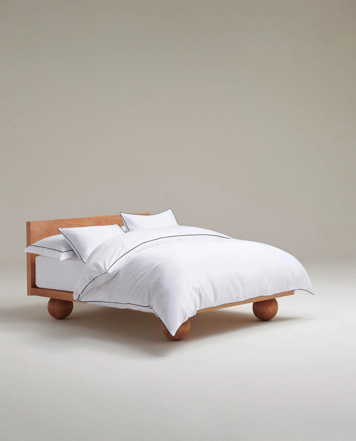 image 2 of 5 showing Rise & Fall's Soft & Smooth duvet set, colour: white with navy piping, fabric: sateen cotton