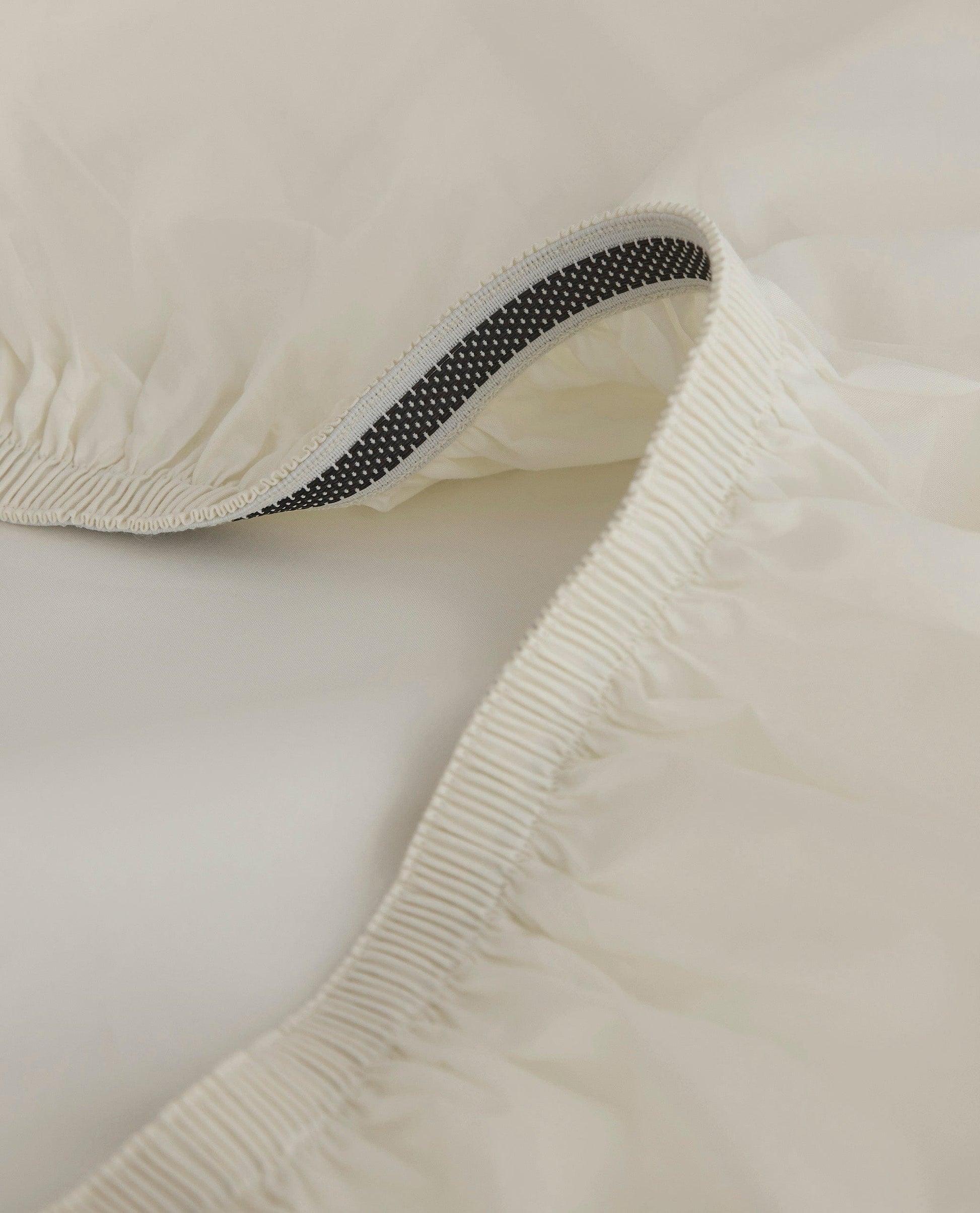 Image 2 of 5 showing Rise & Fall's Crisp & Cool organic cotton deep fitted sheet in buttermilk.