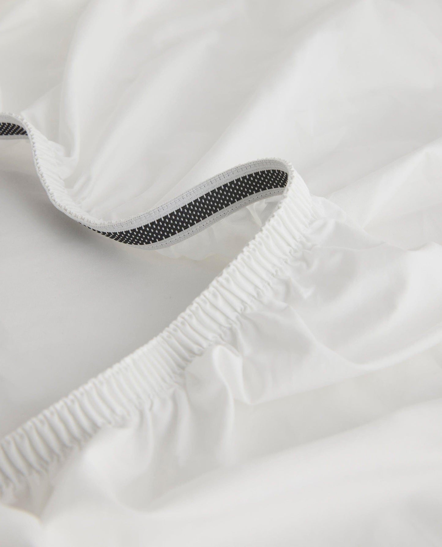 Image 2 of 6 showing Rise & Fall's white Soft & Smooth sateen cotton deep fitted sheet.