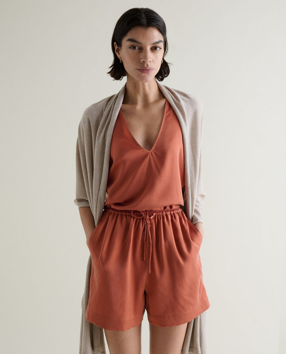 Image 2 of 6 showing woman with Rise & Fall's oversized cashmere scarf around shoulders, colour: light beige