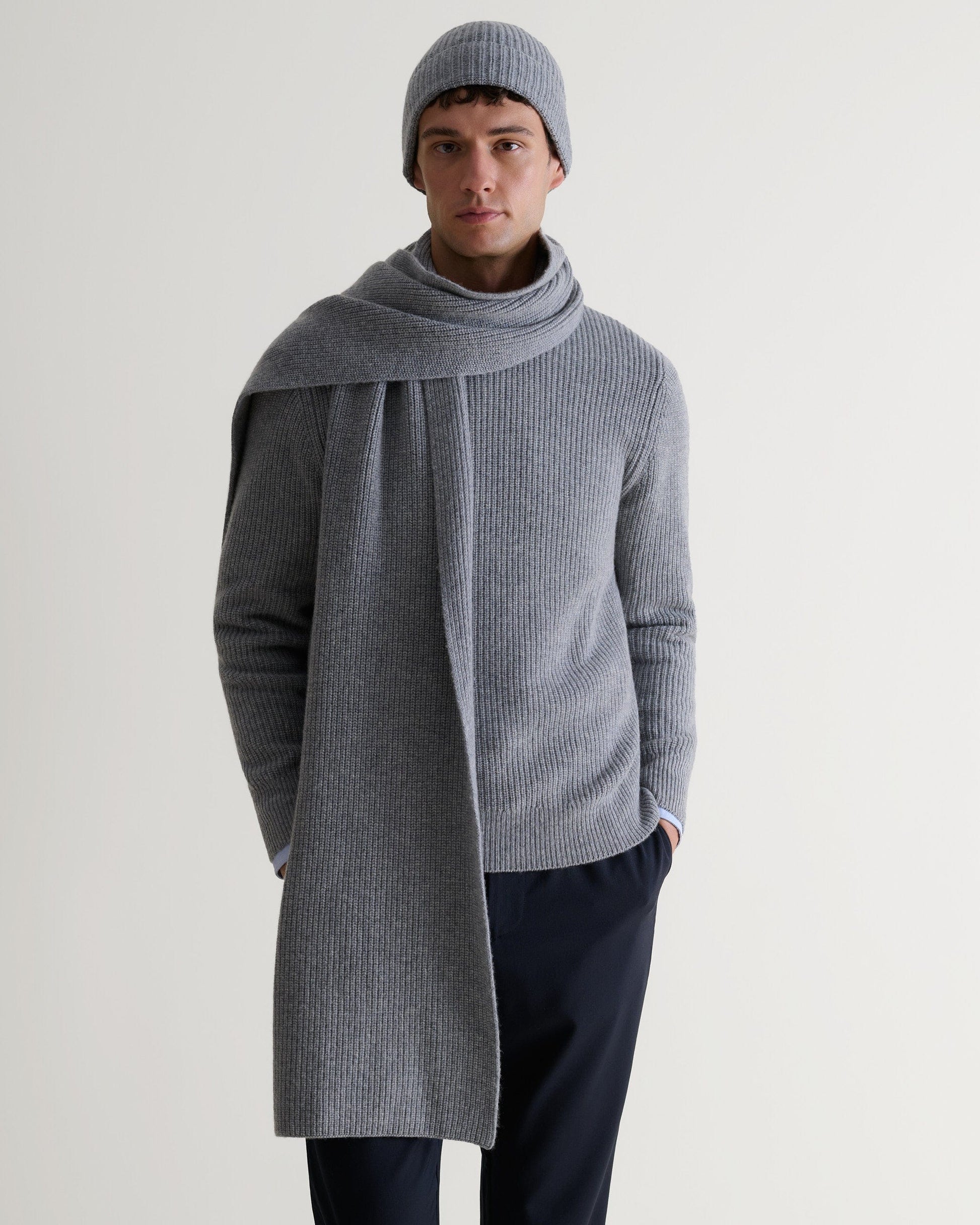 Image 3 of 4 showing man wearing Rise & Fall's Cashmere Merino Ribbed Knit Beanie in grey.