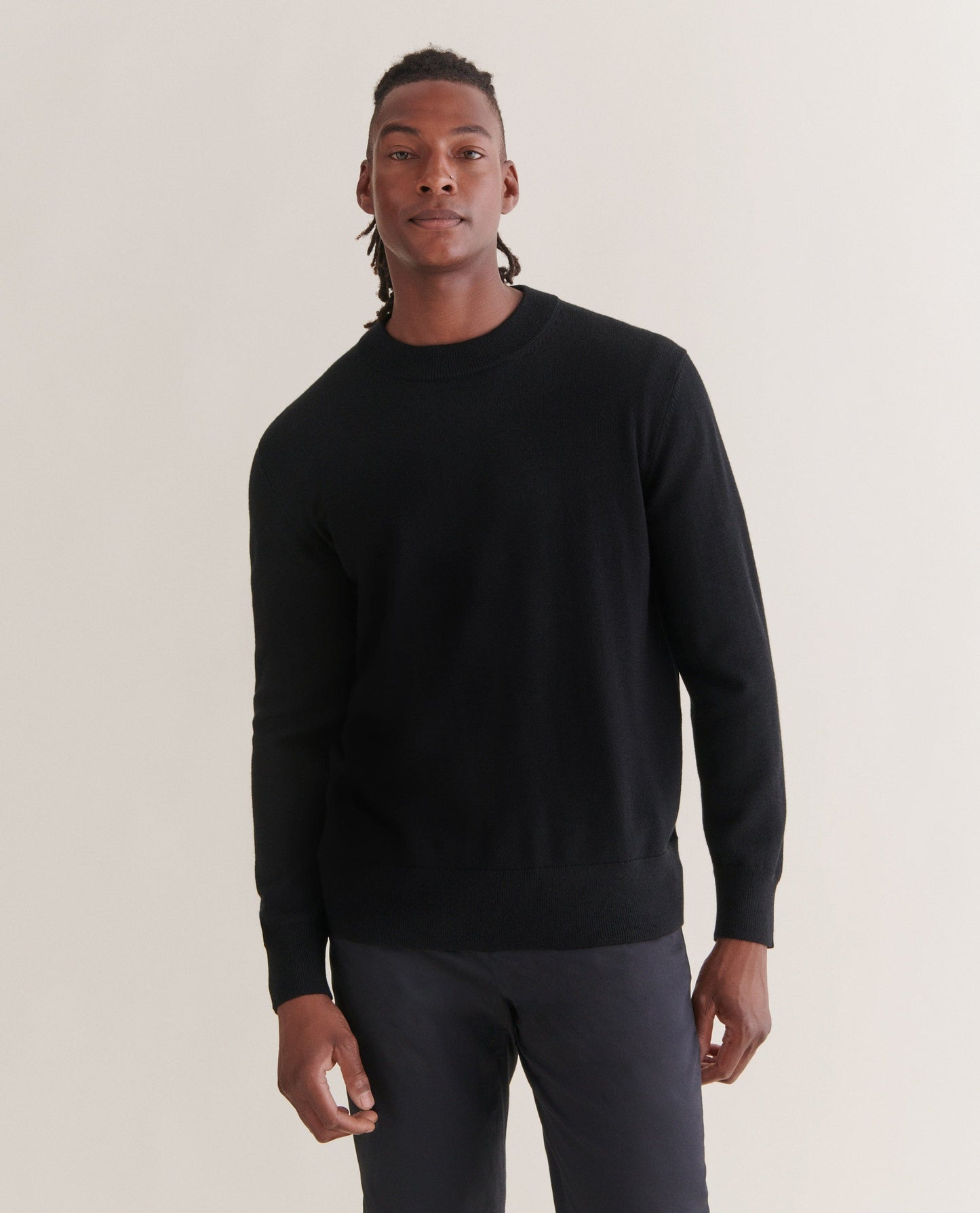 Image 3 of 4 showing man wearing Rise & Fall's merino mid-weight crew neck jumper in black.