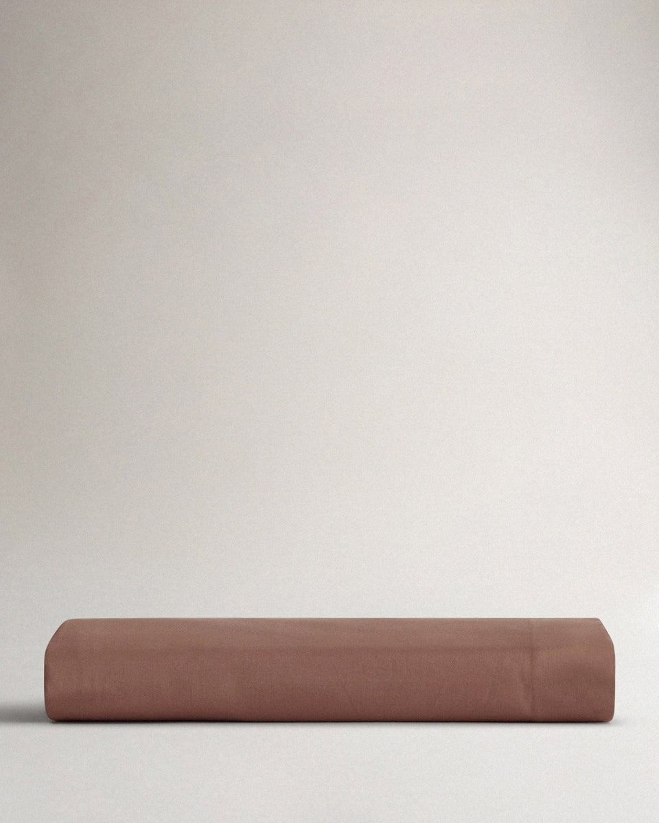 Image 3 of 4 showing Rise & Fall's Soft & Smooth organic sateen cotton flat sheet in deep clay. 
