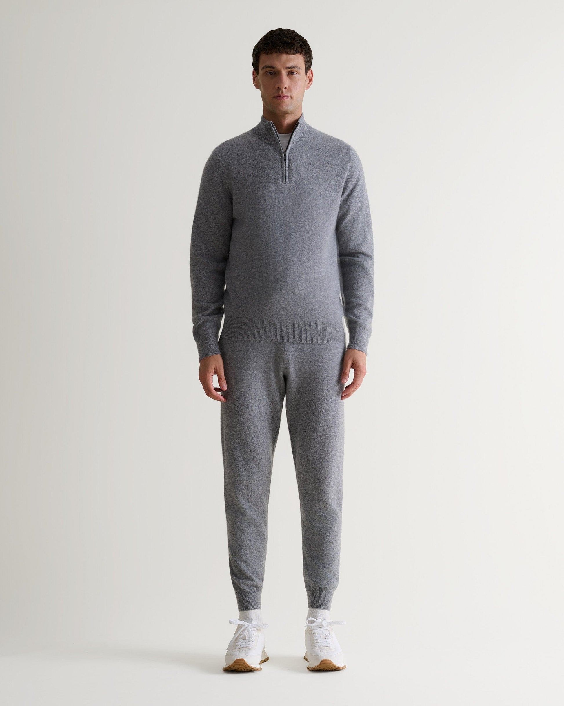 Image 3 of 5 showing man wearing Rise & Fall's fine cashmere 1/4 zip jumper, grey.