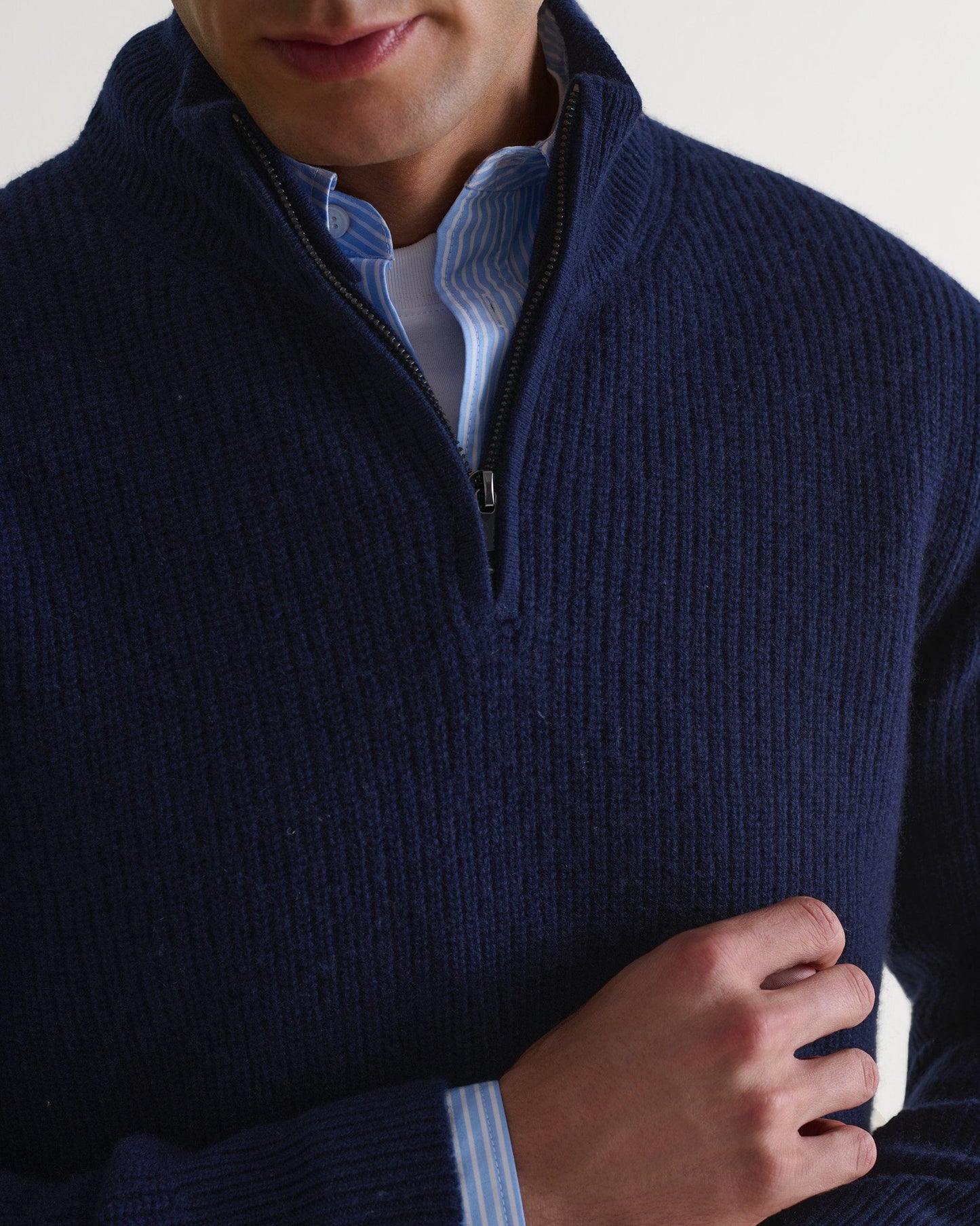 Image 3 of 5 showing close up of man wearing Rise & Fall's Cashmere Merino Fishermans Rib 1/4 Zip Jumper in navy.