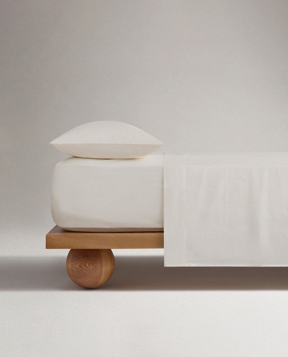 Image 3 of 5 showing Rise & Fall's Crisp & Cool organic percale cotton deep fitted bed sheet in buttermilk. 