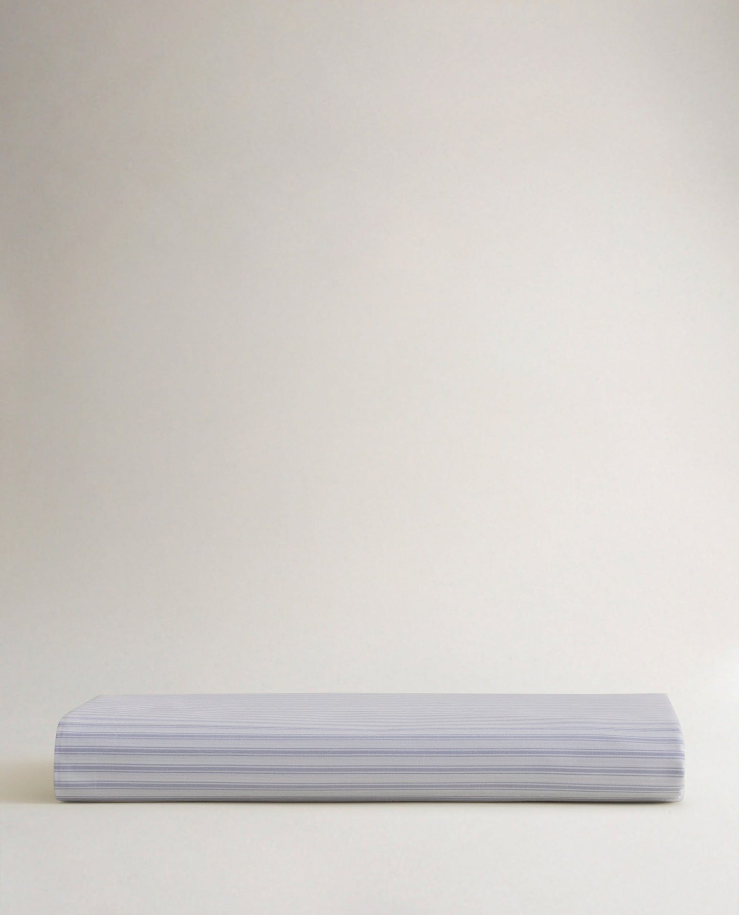 Image 3 of 5 showing Rise & Fall's Crisp & Cool organic percale cotton flat bed sheet in blue ticking stripe.