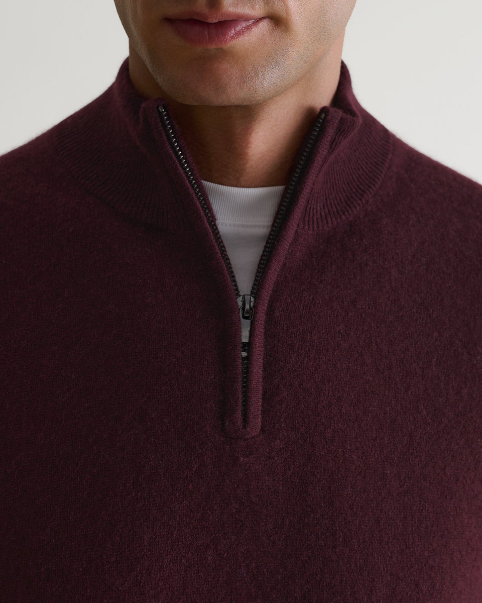 Image 3 of 6 showing man wearing Rise & Fall's fine cashmere 1/4 zip jumper, oxblood, close up.