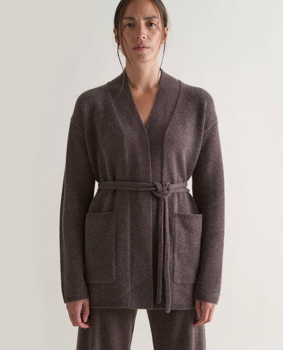 Image 3 of 6 showing woman wearing Rise & Fall's brown cashmere merino belted cardigan with matching cashmere trousers.