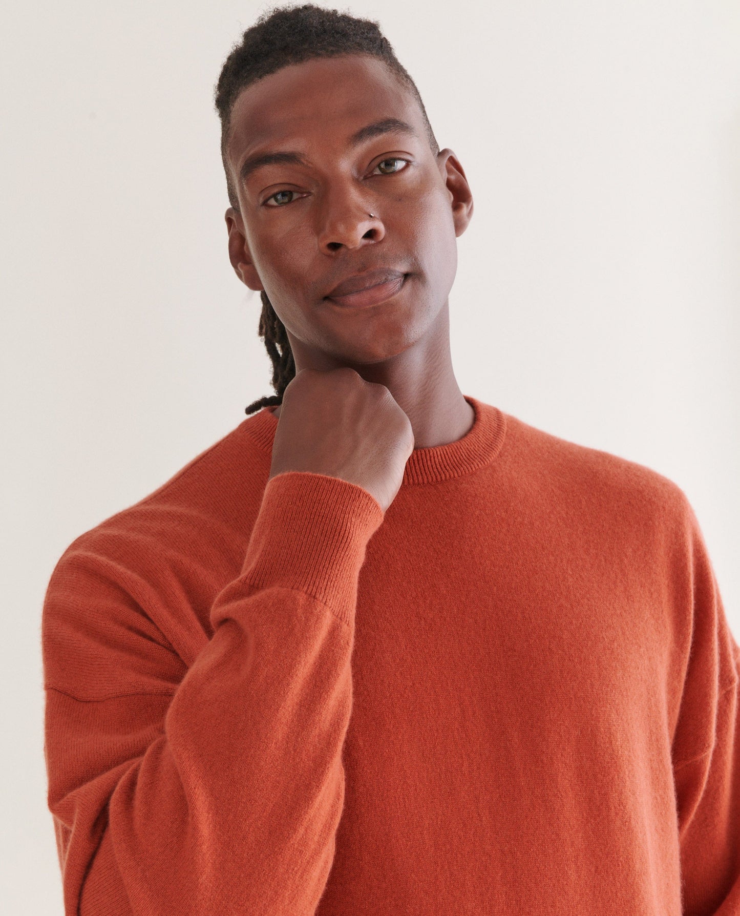 Image 4 of 4 showing man wearing Rise & Fall's finest cashmere sweatshirt in rust.