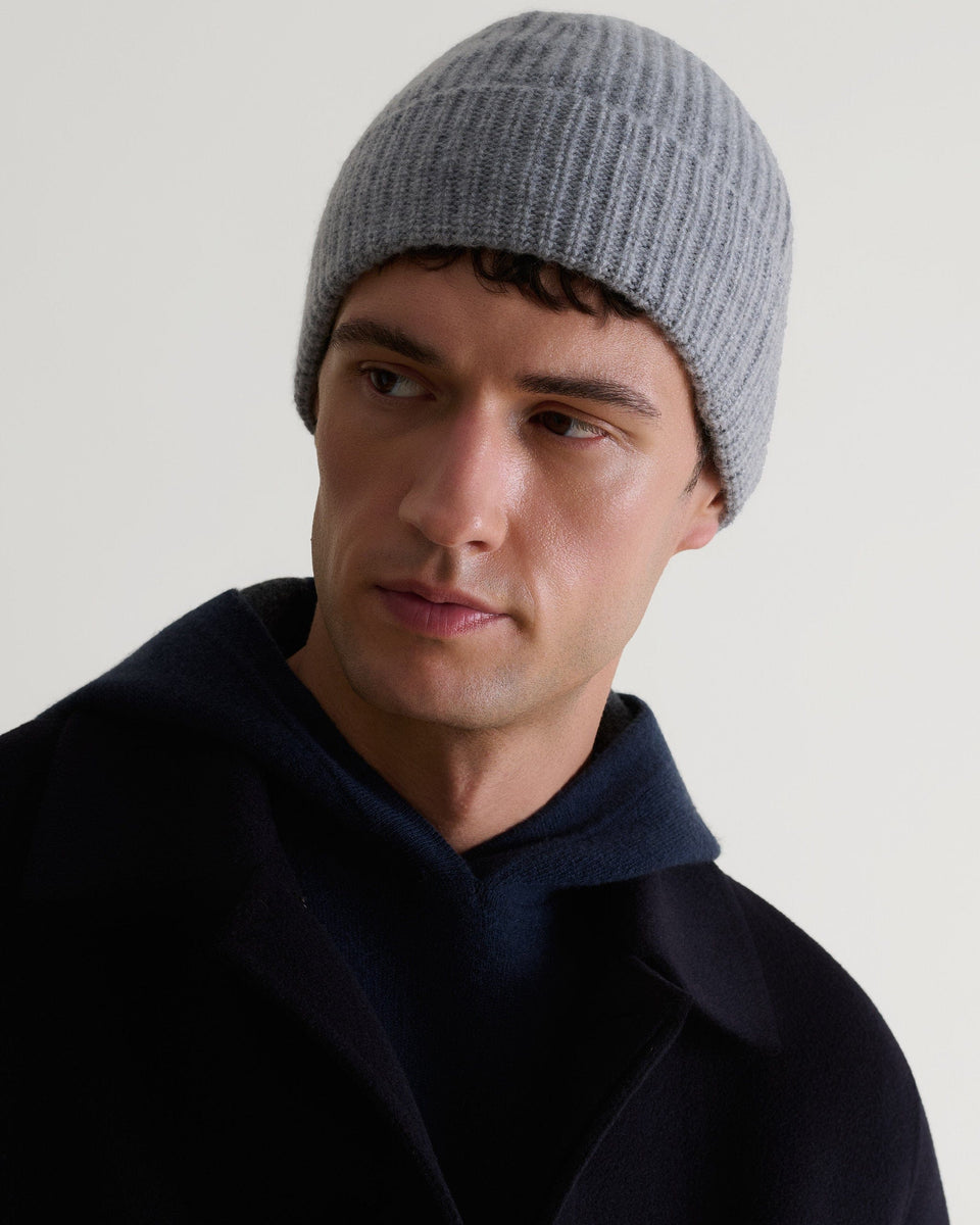 Image 4 of 4 showing man wearing Rise & Fall's Cashmere Merino Ribbed Knit Beanie in grey.