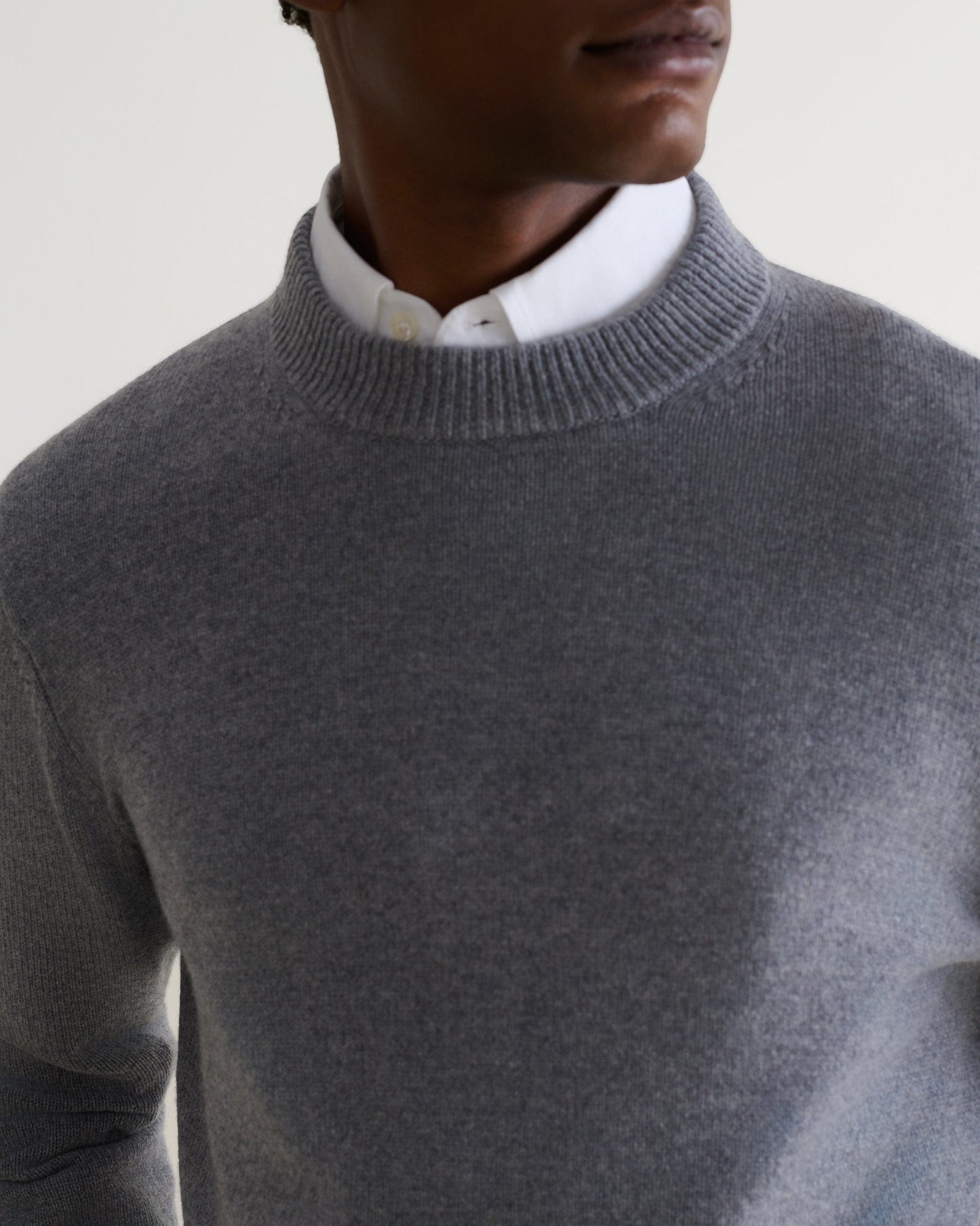 Image 4 of 5 showing close up of man wearing Rise & Fall's finest cashmere mid-weight crew neck jumper in grey with white shirt.