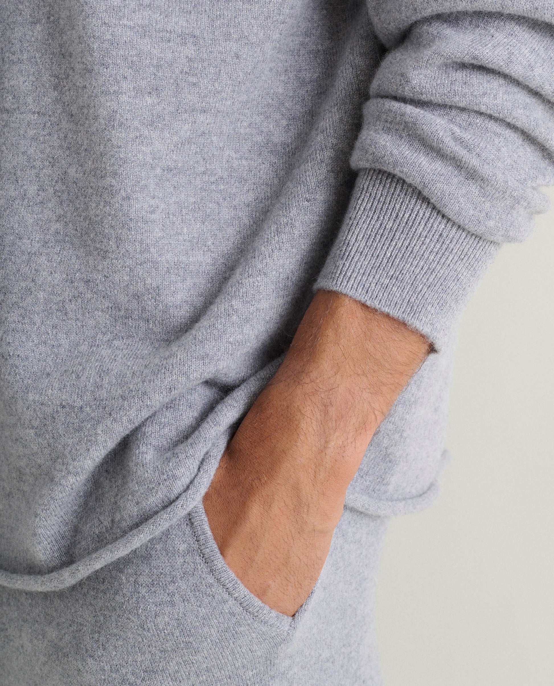 Image 4 of 5 showing close up of man wearing Rise & Fall's finest cashmere sweatshirt in grey with matching joggers.