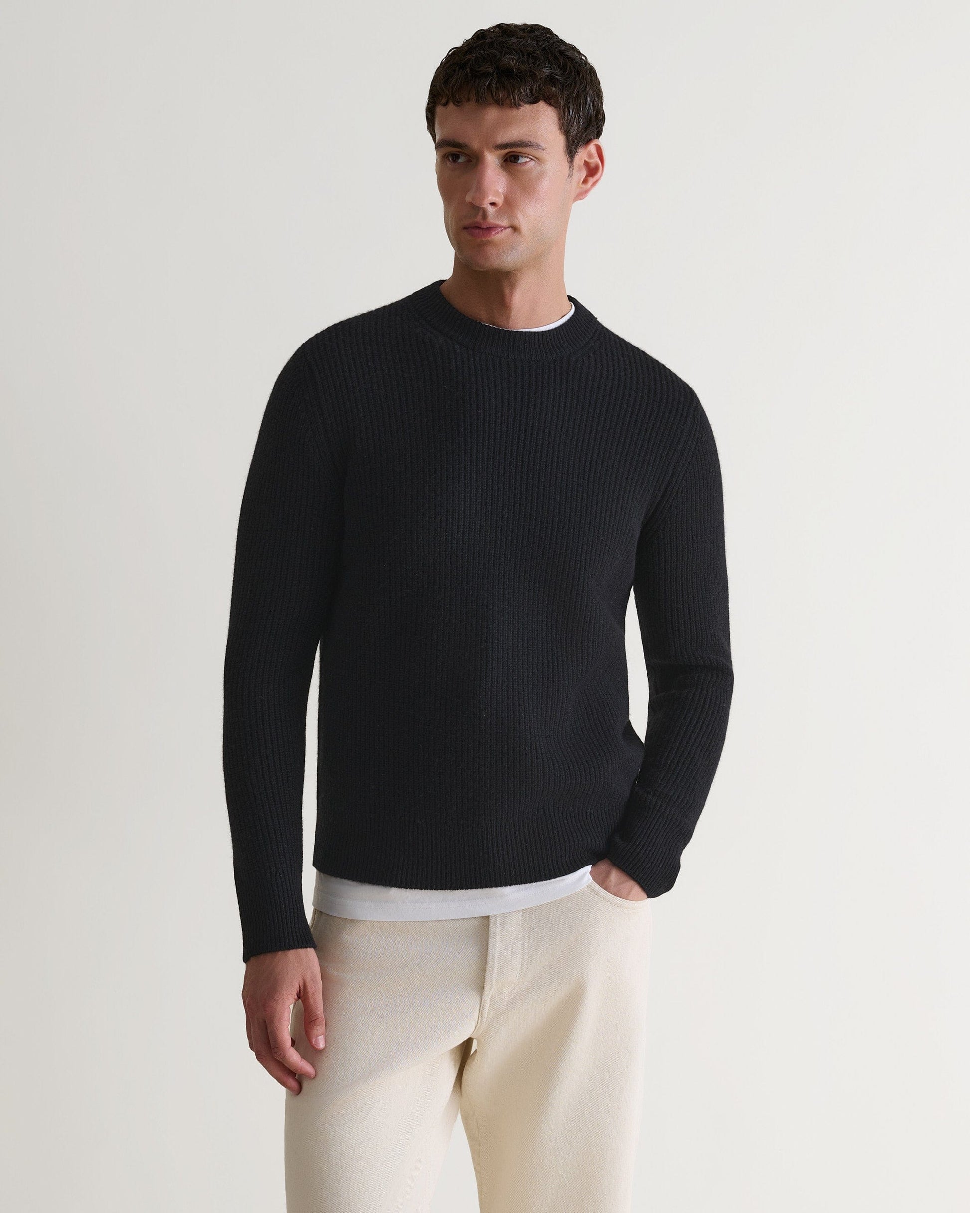 Image 4 of 5 showing man wearing Rise & Fall's Cashmere Merino Fishermans Rib Crew Neck Jumper in black.