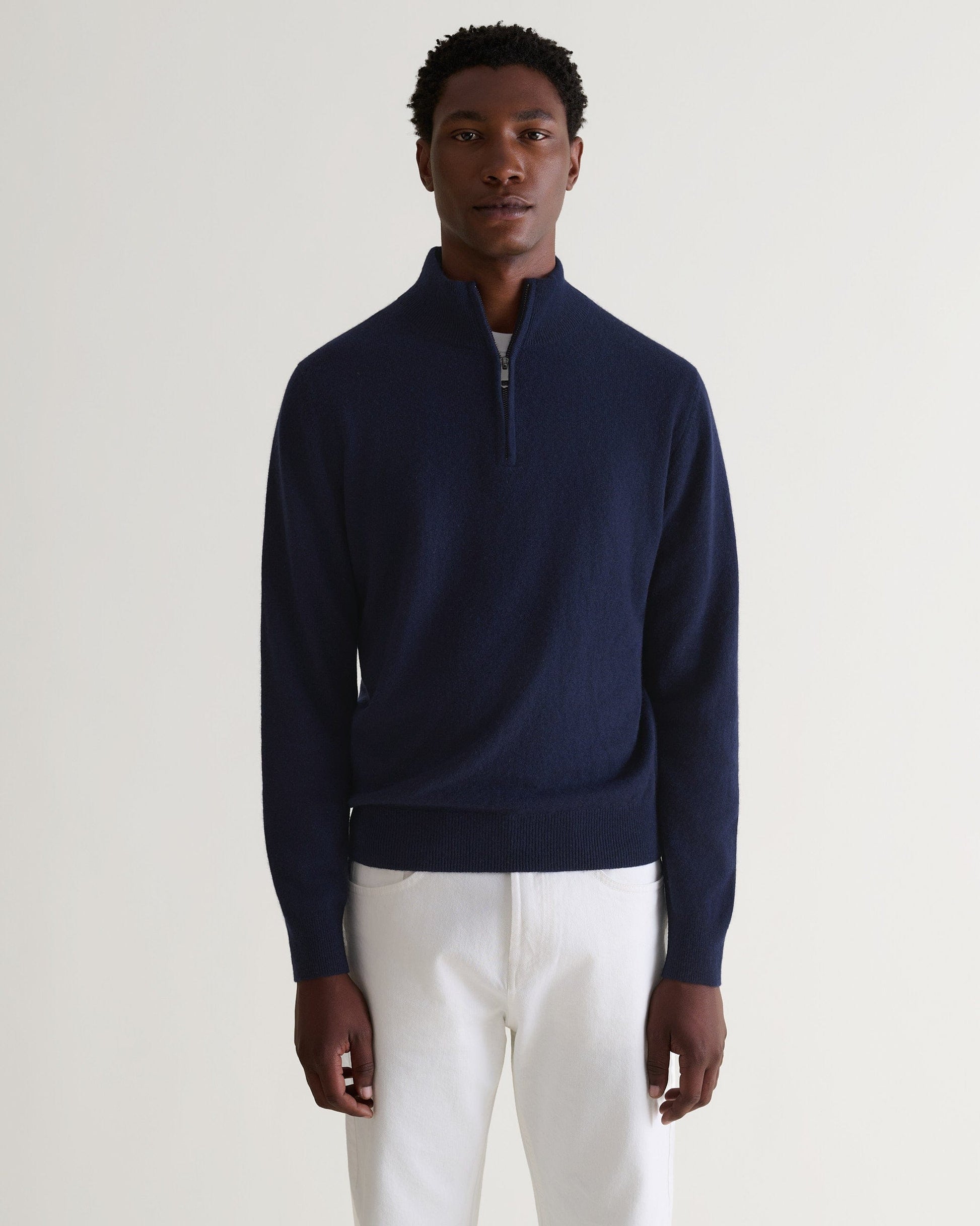 Image 4 of 5 showing man wearing Rise & Fall's fine cashmere 1/4 zip jumper, navy.