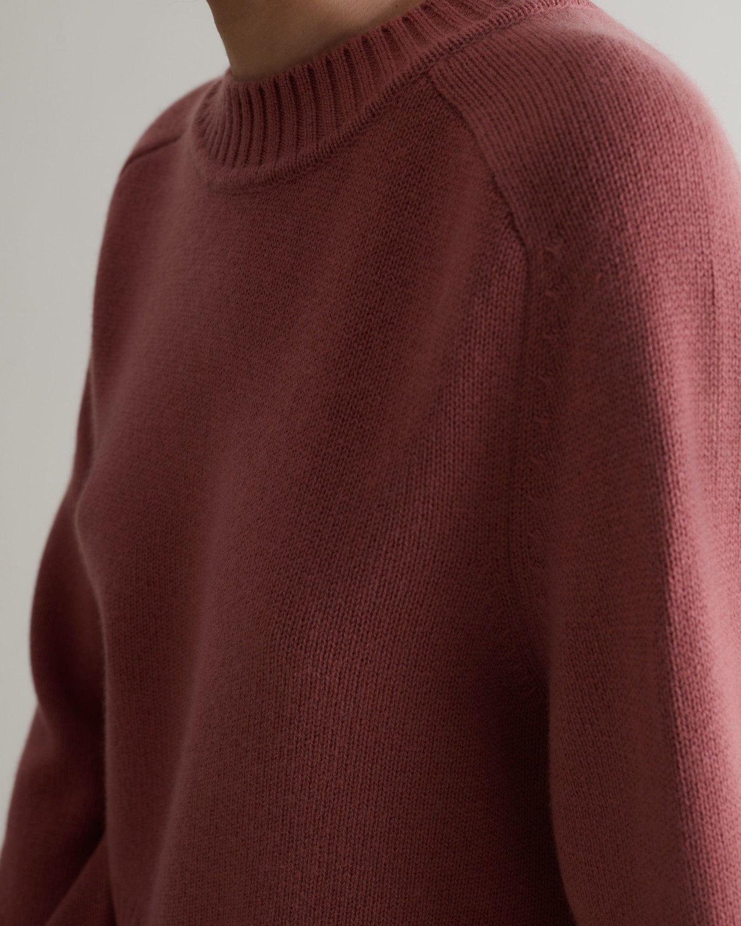 Image 4 of 5 showing close up of Rise & Fall cashmere merino saddle sleeve crew neck jumper, colour: pink clay.