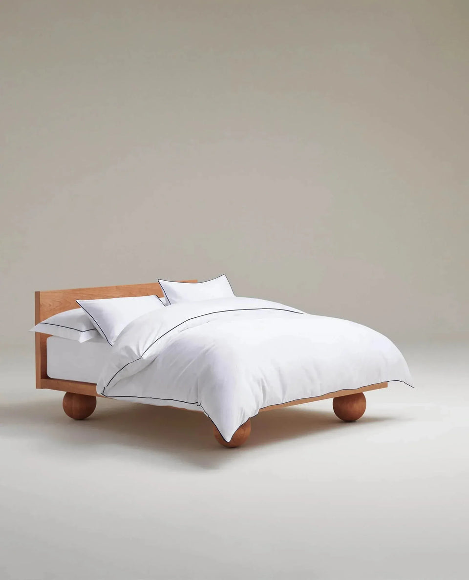 Image 4 of 5 showing Rise & Fall's Soft & Smooth organic sateen cotton comforter set, colour: white navy piping, size: king.