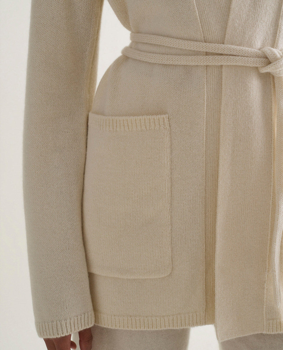 Image 4 of 5 showing close up of woman wearing Rise & Fall's cream cashmere merino belted cardigan.