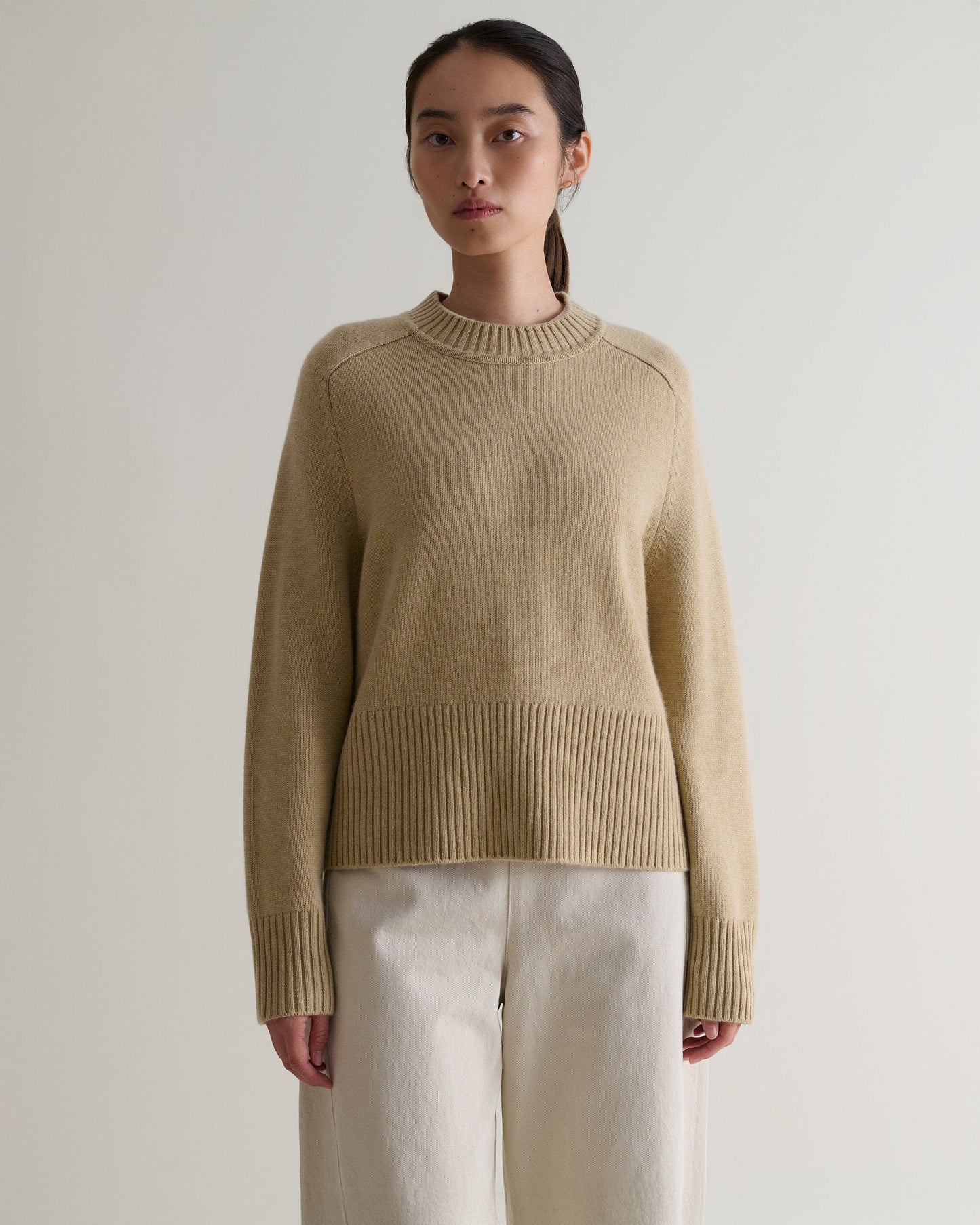 Image 4 of 5 showing woman wearing Rise & Fall twine cashmere merino saddle sleeve crew neck with cream jeans.