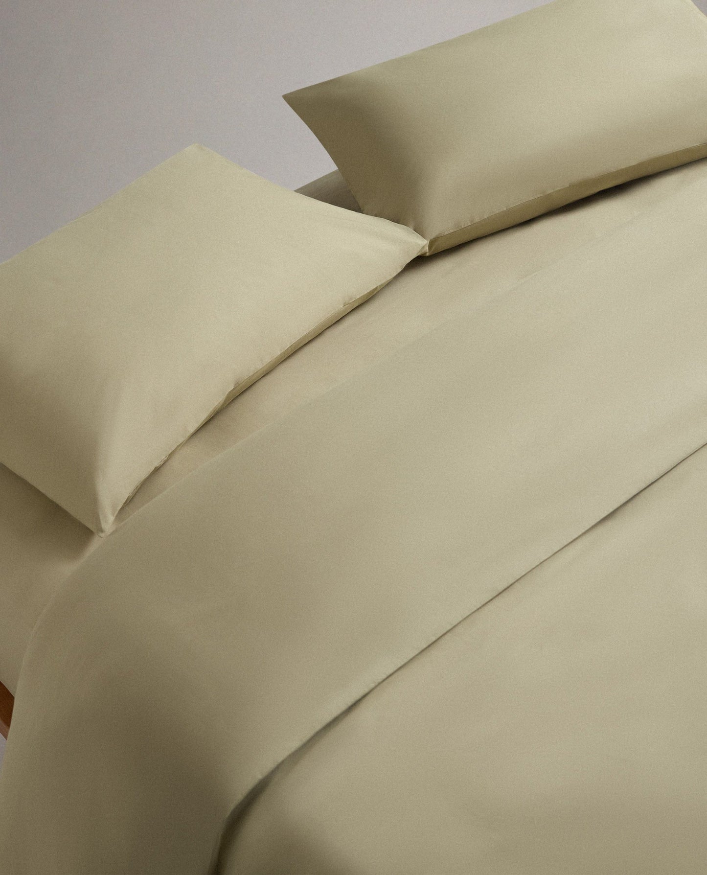Image 4 of 6 showing bed made with Rise & Fall's Crisp & Cool organic cotton duvet set in sage.