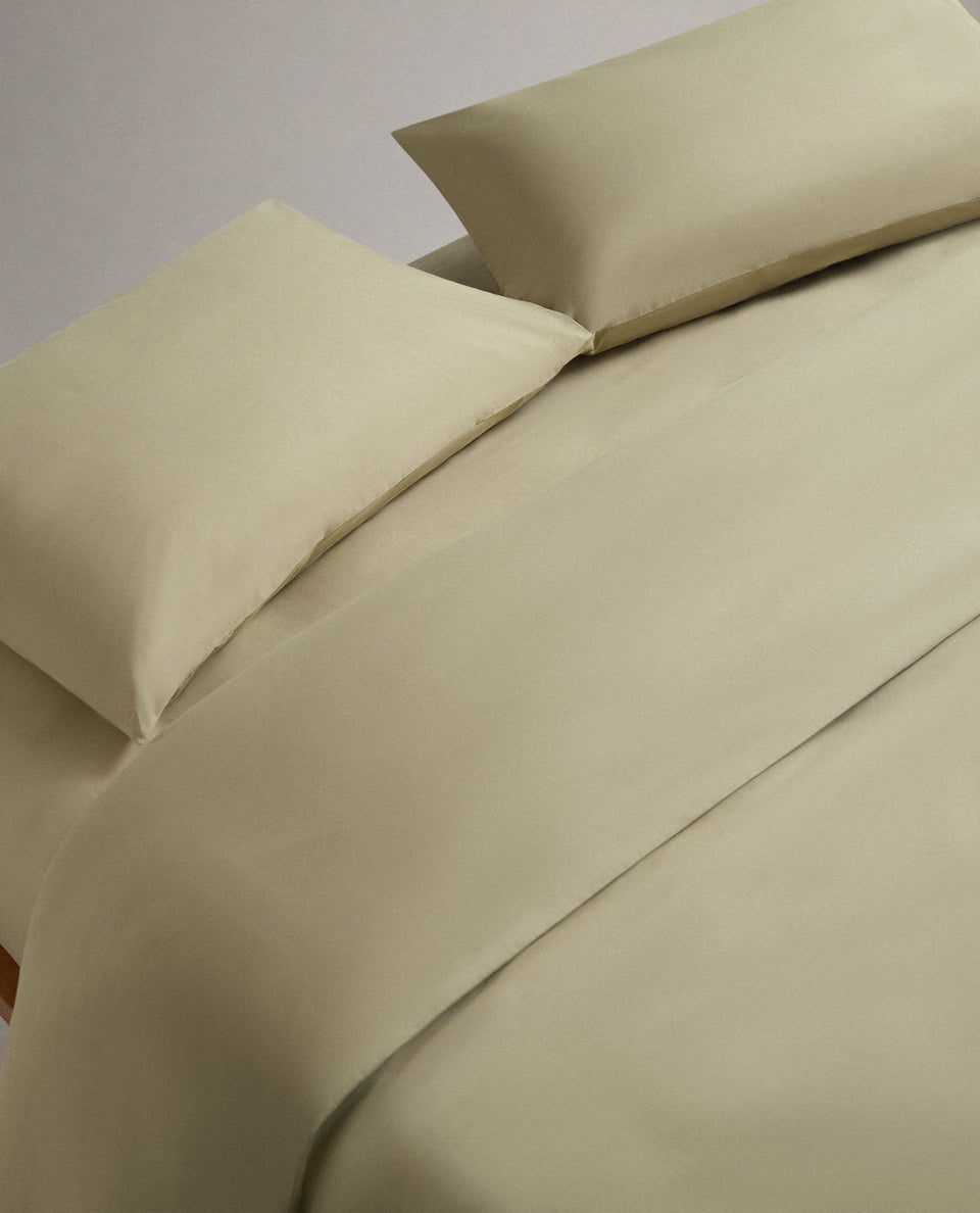 Image 4 of 6 showing bed made with Rise & Fall's Crisp & Cool organic cotton duvet set in sage.