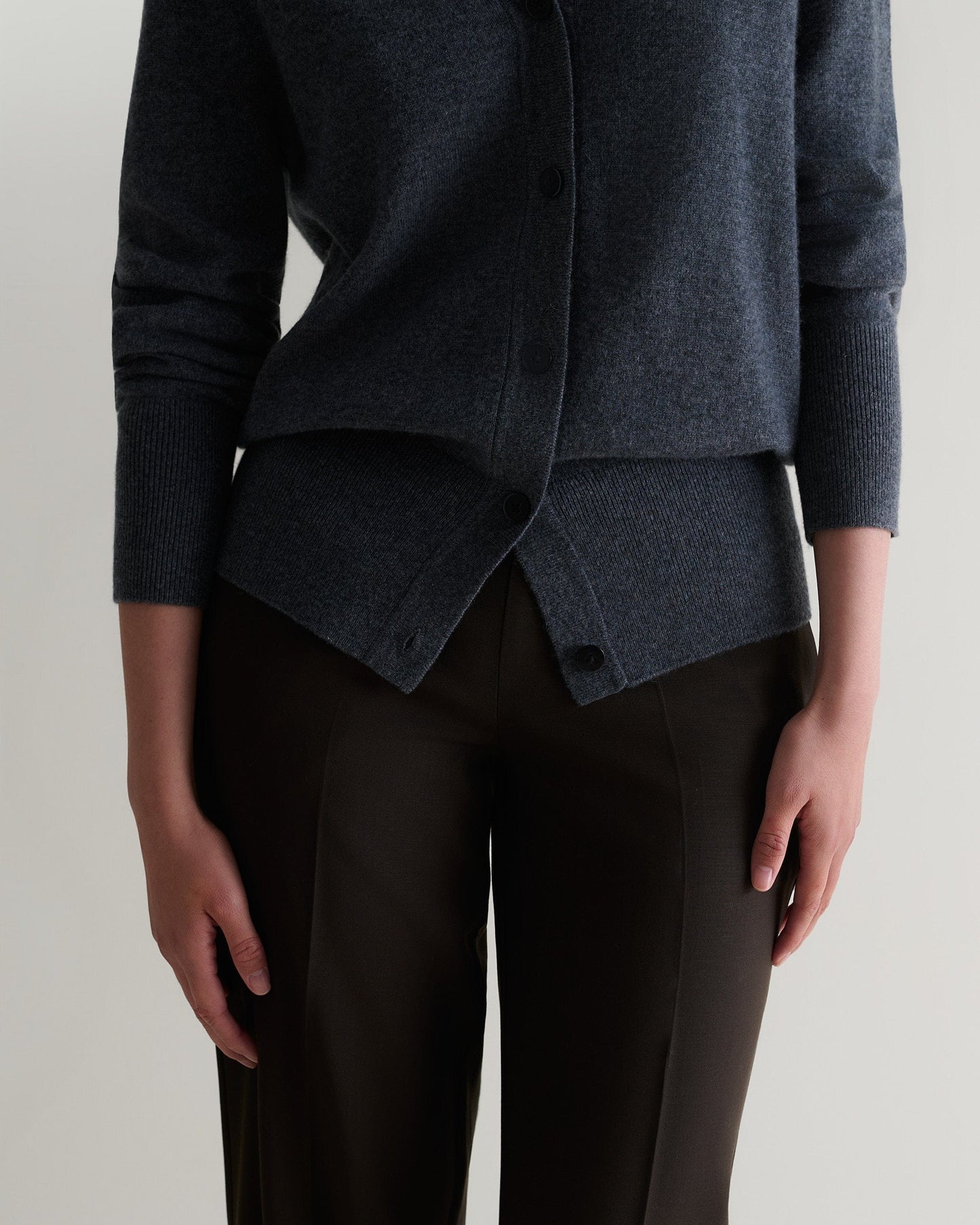 Image 5 of 5 showing close up of woman wearing Rise & Fall's fine cashmere blouson cardigan, colour: graphite.