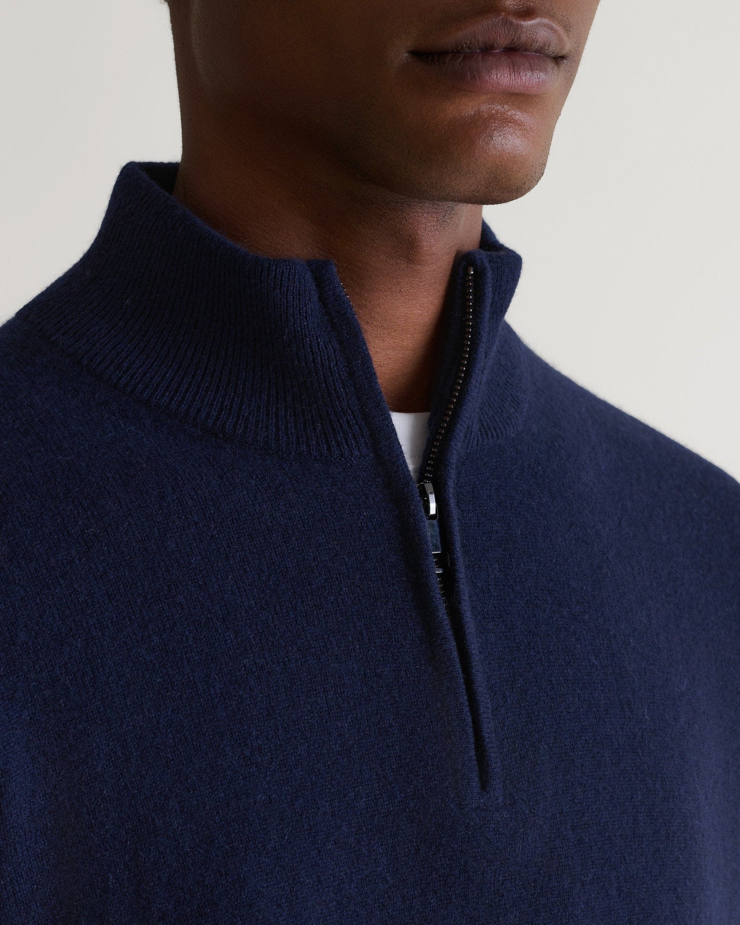 Image 5 of 5 showing man wearing Rise & Fall's fine cashmere 1/4 zip jumper, navy, close up.