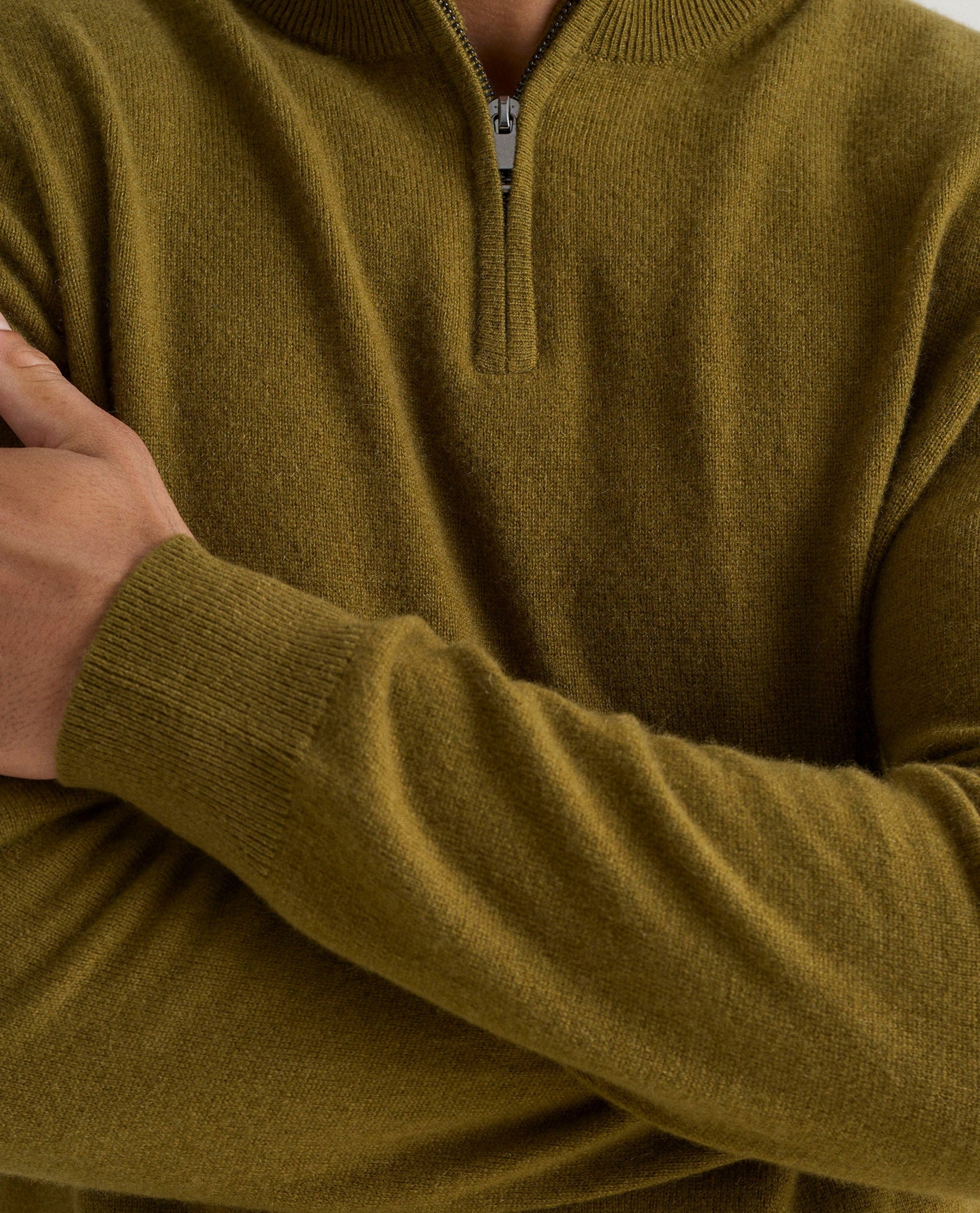 Image 5 of 5 showing man wearing Rise & Fall's fine cashmere 1/4 zip jumper, olive, close up.