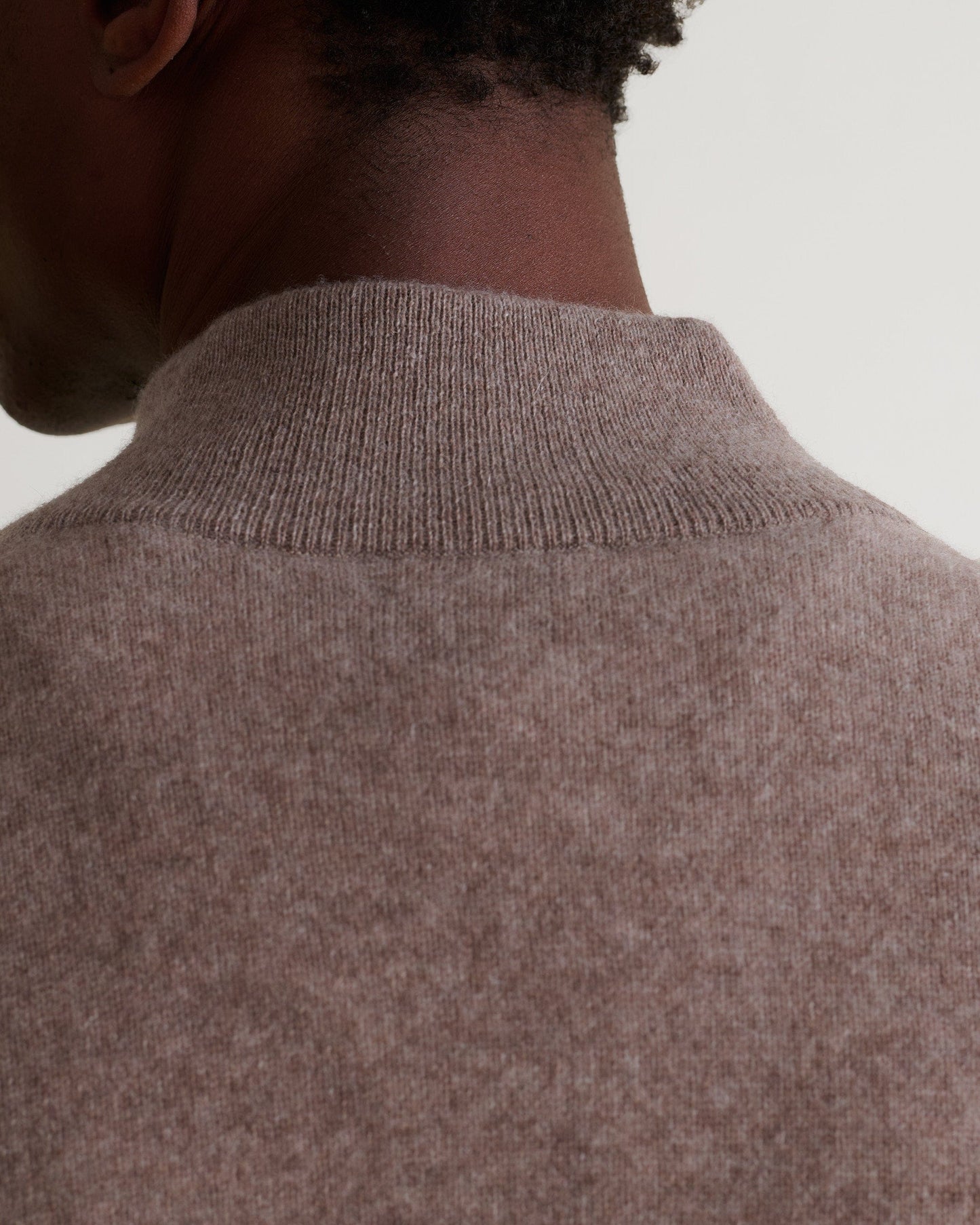 Image 5 of 5 showing man wearing Rise & Fall's fine cashmere 1/4 zip jumper, toast, close up.