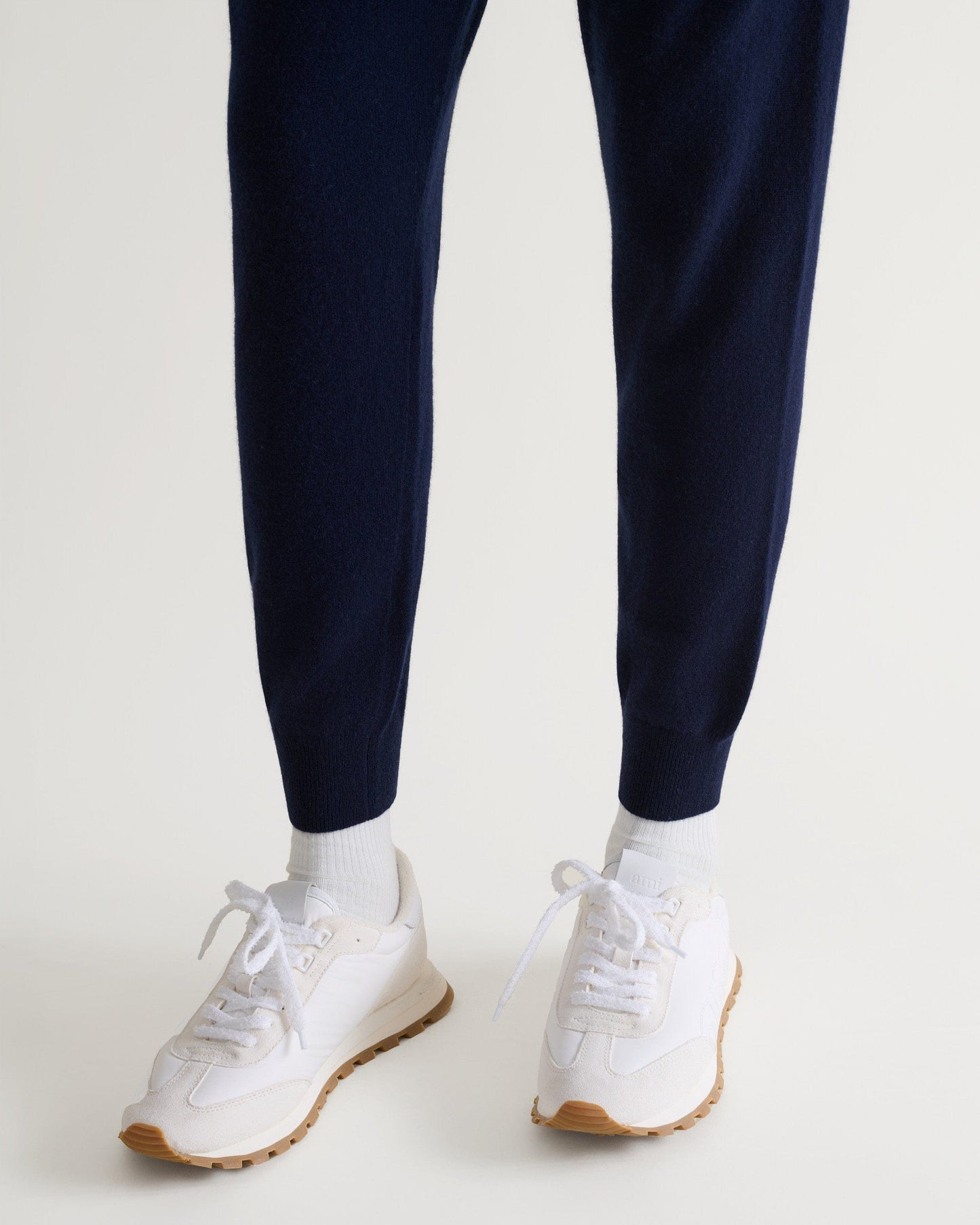 Image 5 of 5 showing man wearing Rise & Fall's fine cashmere joggers, navy, close-up.