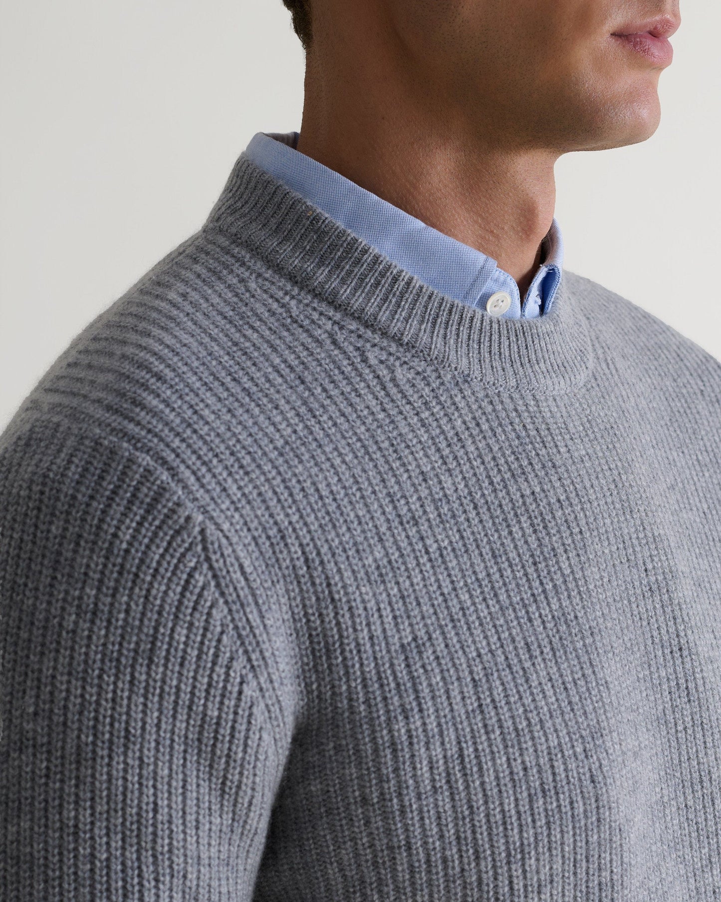 Image 5 of 5 showing close up of man wearing Rise & Fall's Cashmere Merino Fishermans Rib Crew Neck Jumper in grey.