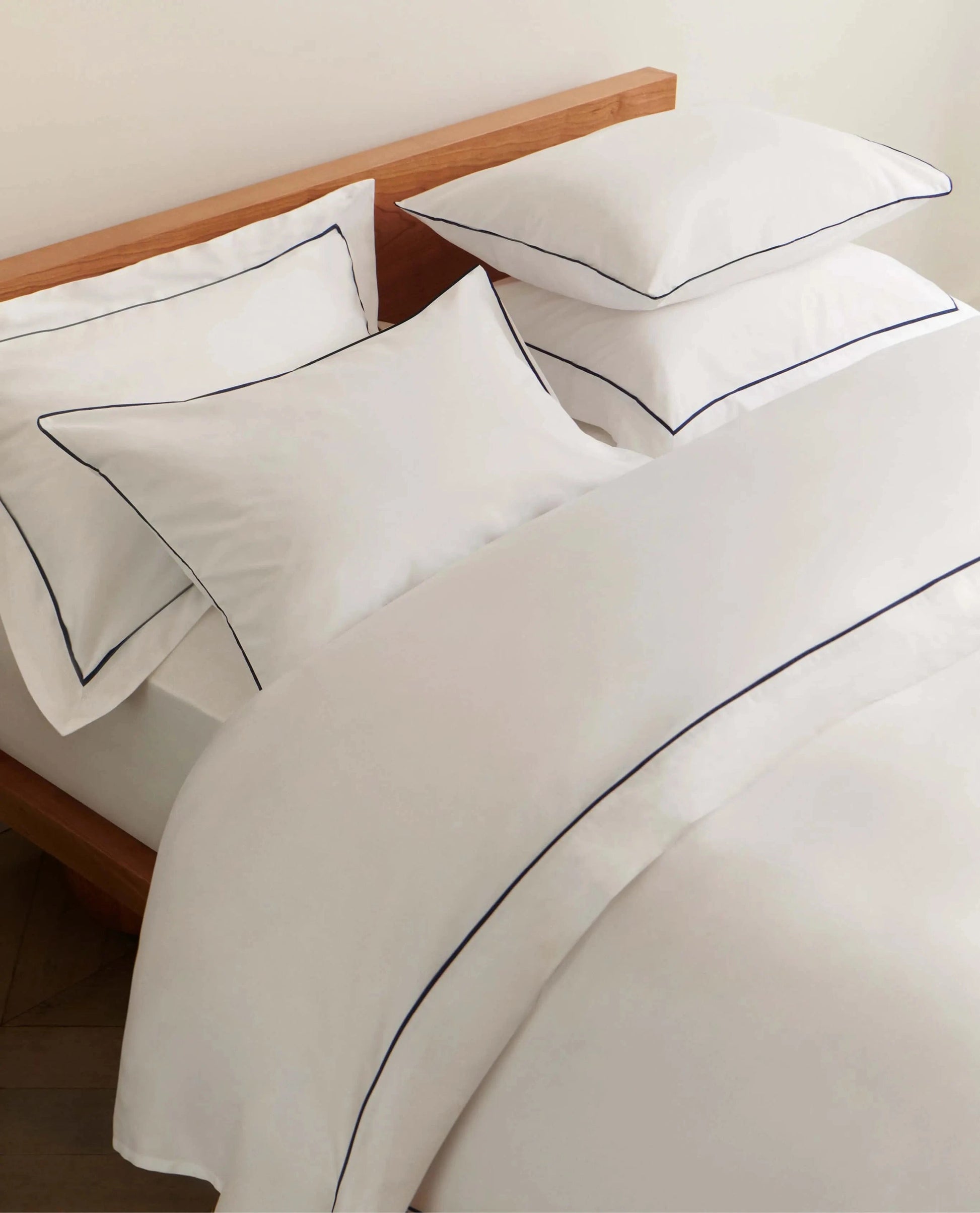image 5 of 5 showing Rise & Fall's Soft & Smooth duvet set, colour: white with navy piping, fabric: sateen cotton