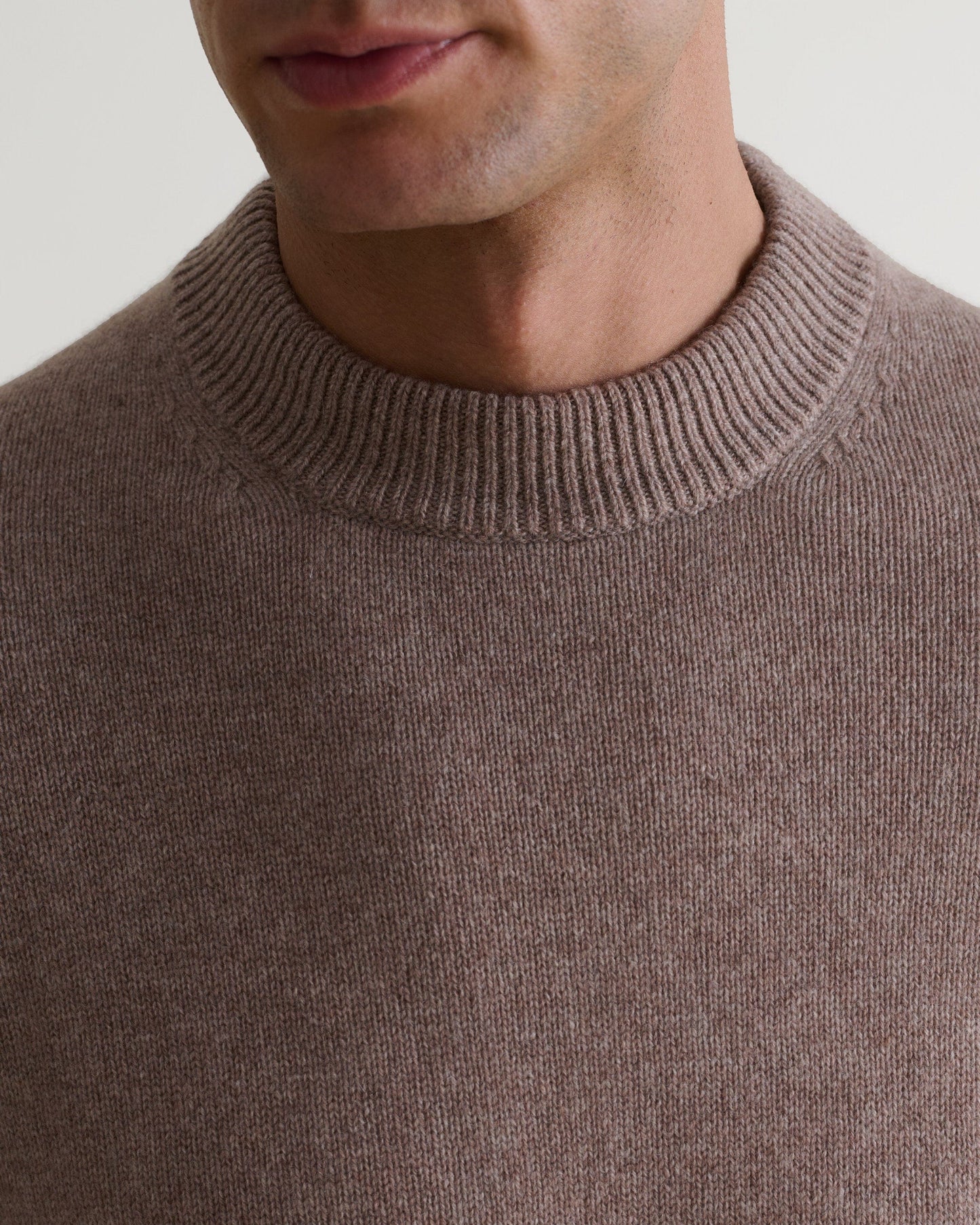 Image 6 of 6 showing close up of man wearing Rise & Fall's Finest Cashmere Mid-Weight Crew Neck Jumper in toast brown.