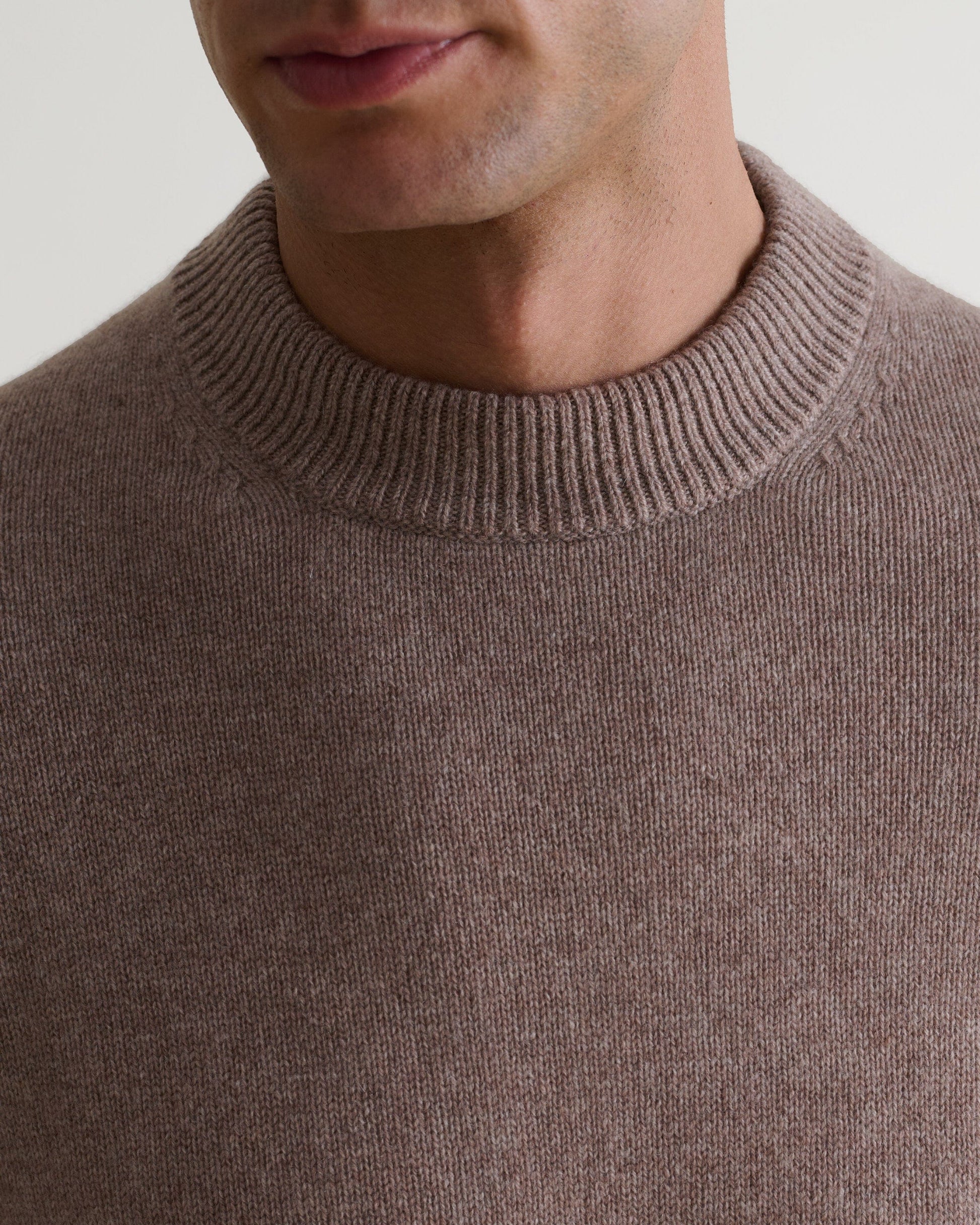 Image 6 of 6 showing close up of man wearing Rise & Fall's Finest Cashmere Mid-Weight Crew Neck Jumper in toast brown.