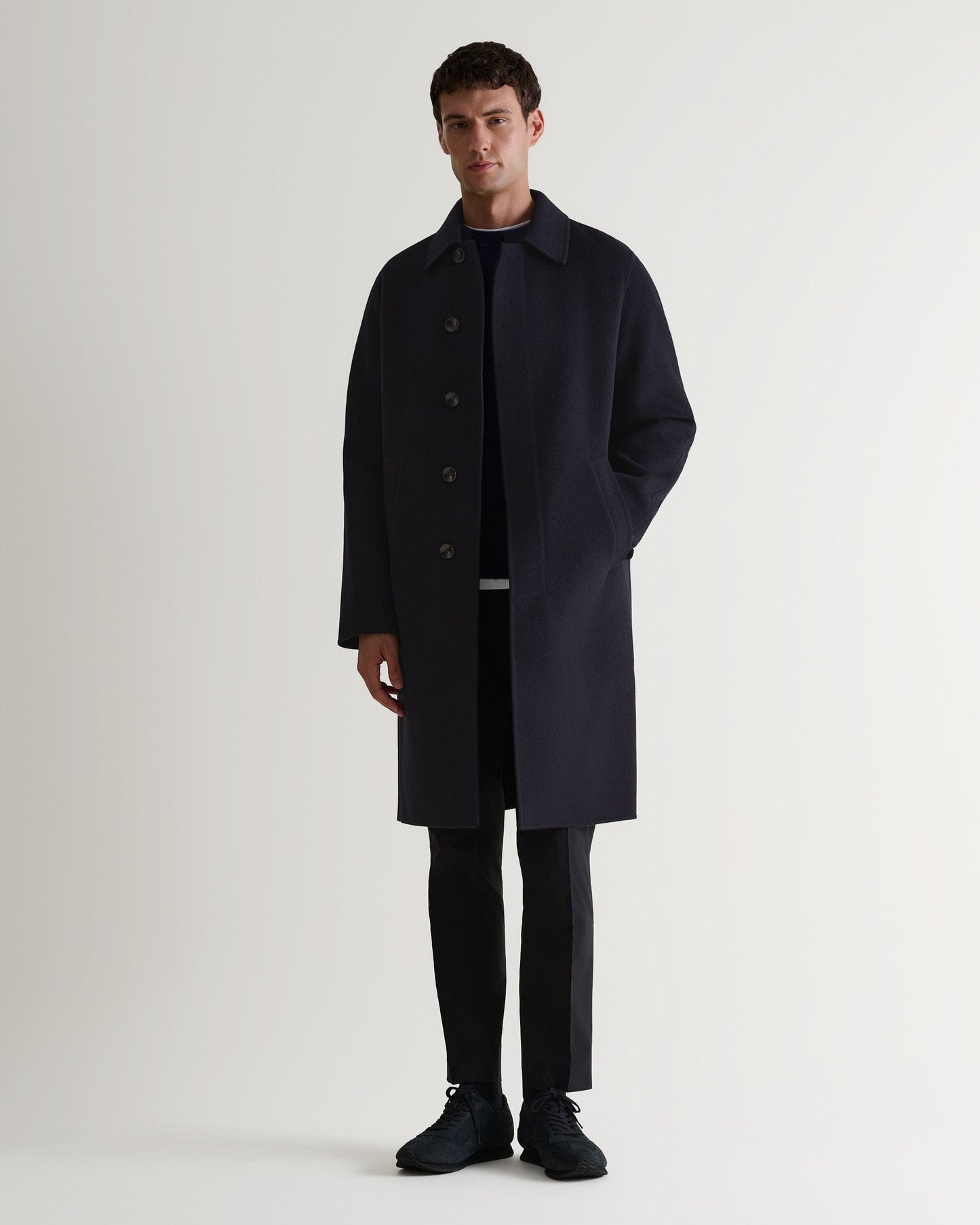 Image 6 of 6 showing man wearing Rise & Fall's navy Cashmere Merino Fishermans Rib Crew Neck Jumper with car coat.