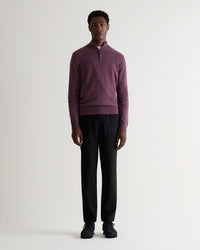 Full length view of man wearing Rise & Fall's finest cashmere 1/4 zip jumper in Smoky Lilac. Paired with black trousers.