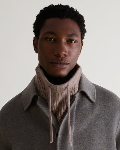 Man wearing toast cashmere merino drawstring snood with grey wool coat